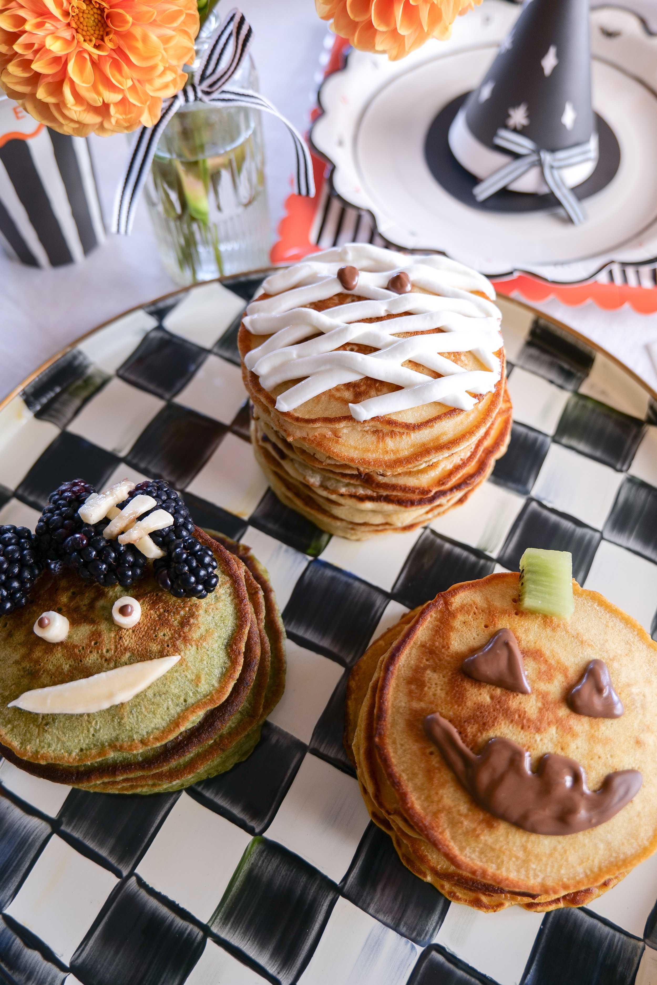 Easy Halloween pancakes for kids decorated with fruit, Greek yogurt and chocolate.