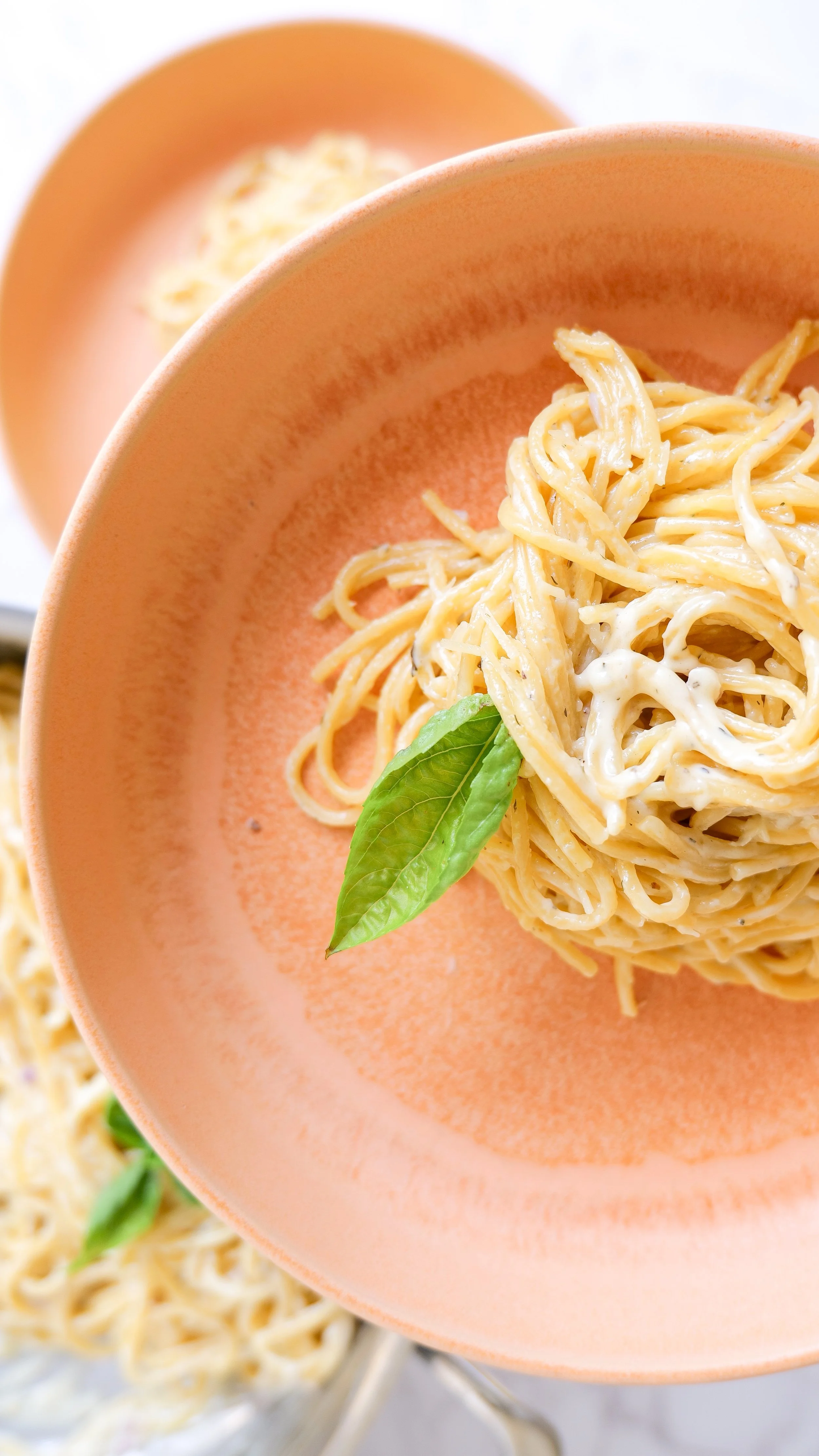 Creamy white pasta sauce with freshly grated Parmesan and black pepper.