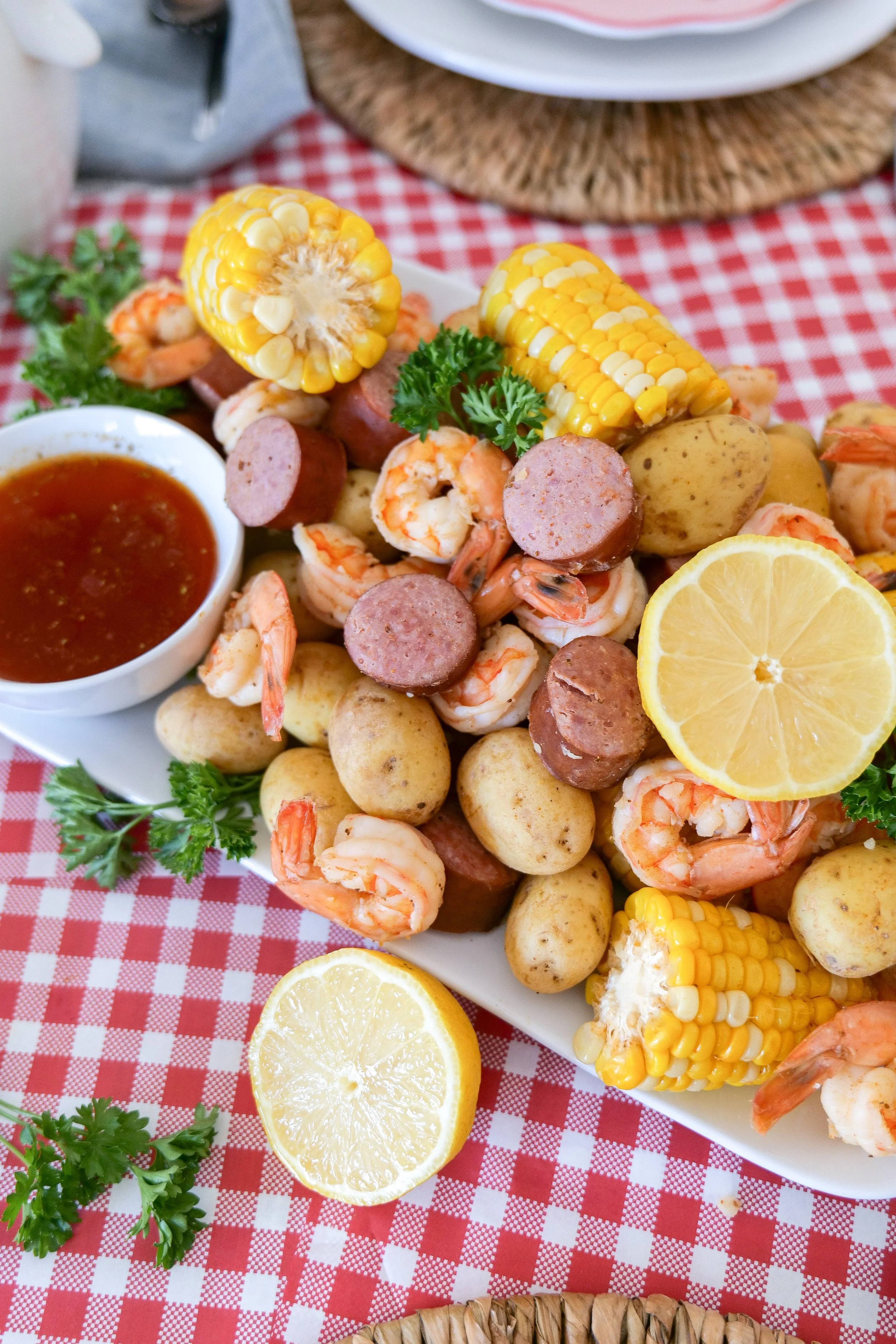 Buttery close-up of a classic shrimp boil with tender shrimp, potatoes, corn, and fresh lemon slices for summer entertaining.