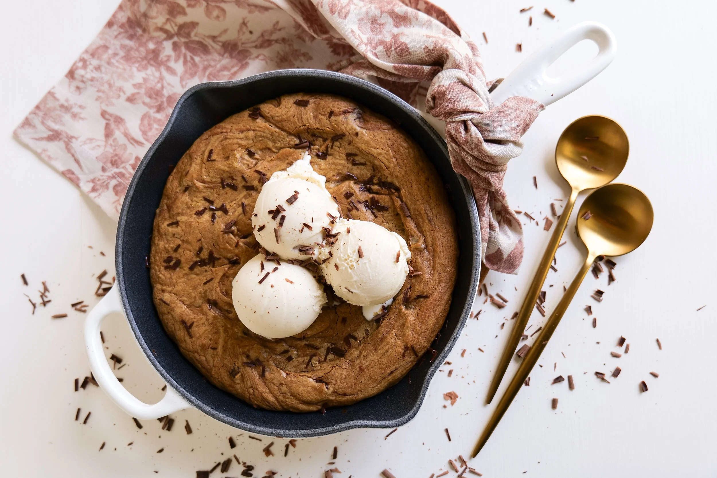 Pumpkin chocolate chip oatmeal cookie dough pressed into a cast iron skillet before baking