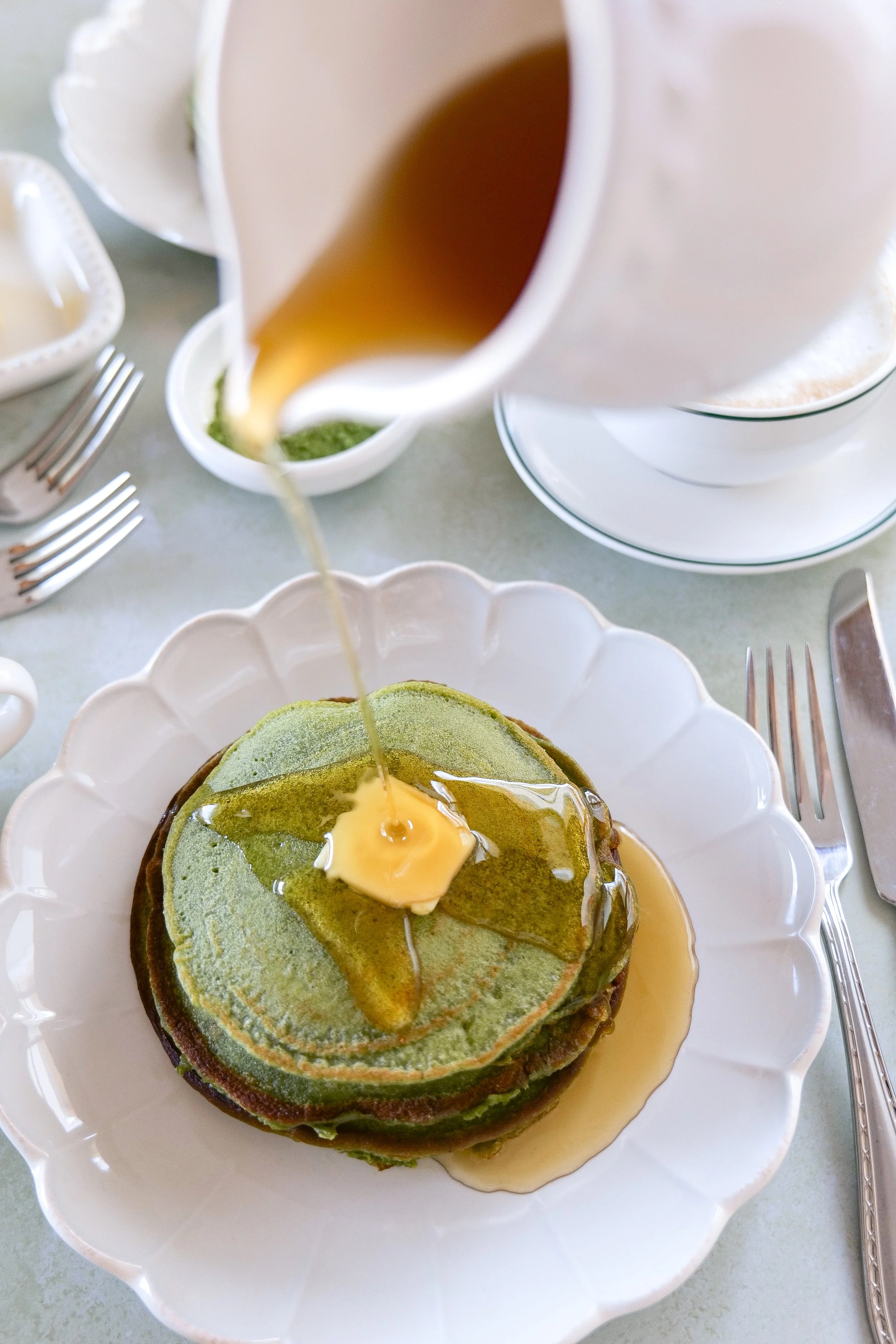green matcha sourdough discard pancakes with syrup drizzle