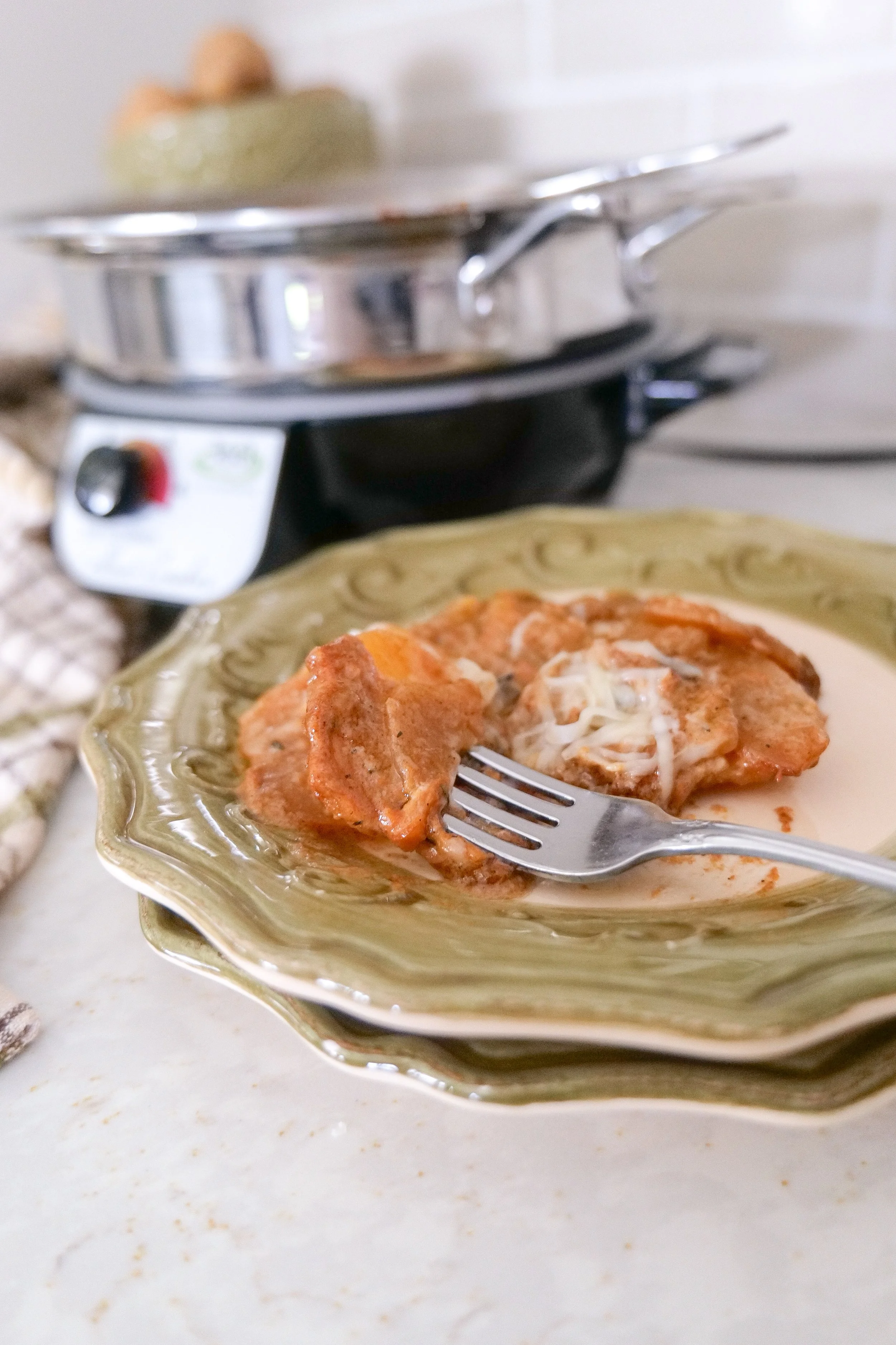 Easy crockpot potato recipe with garlic, onions, Gruyère cheese, and herbs.