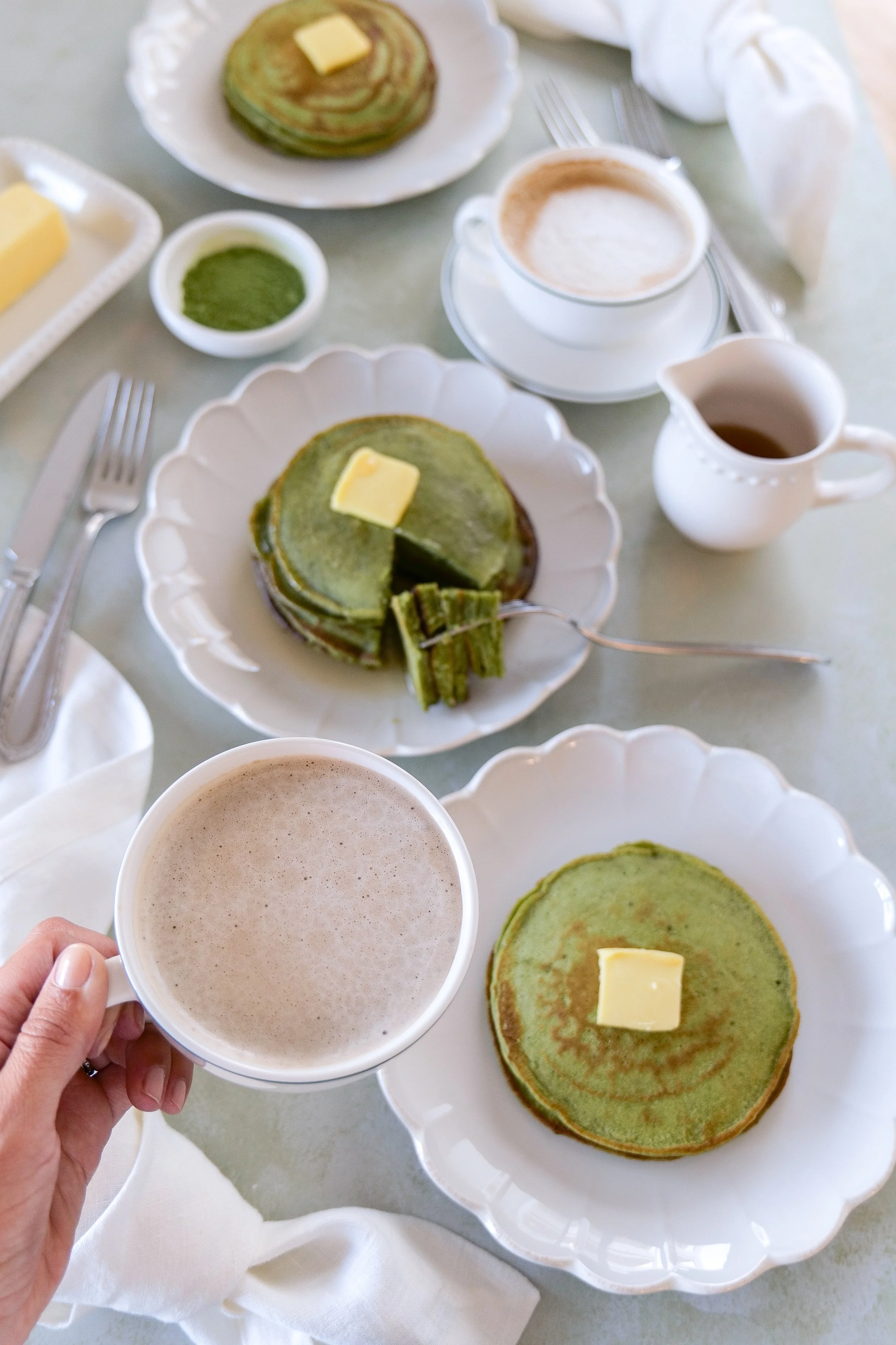 Homemade fluffy matcha sourdough discard pancakes on ceramic plate