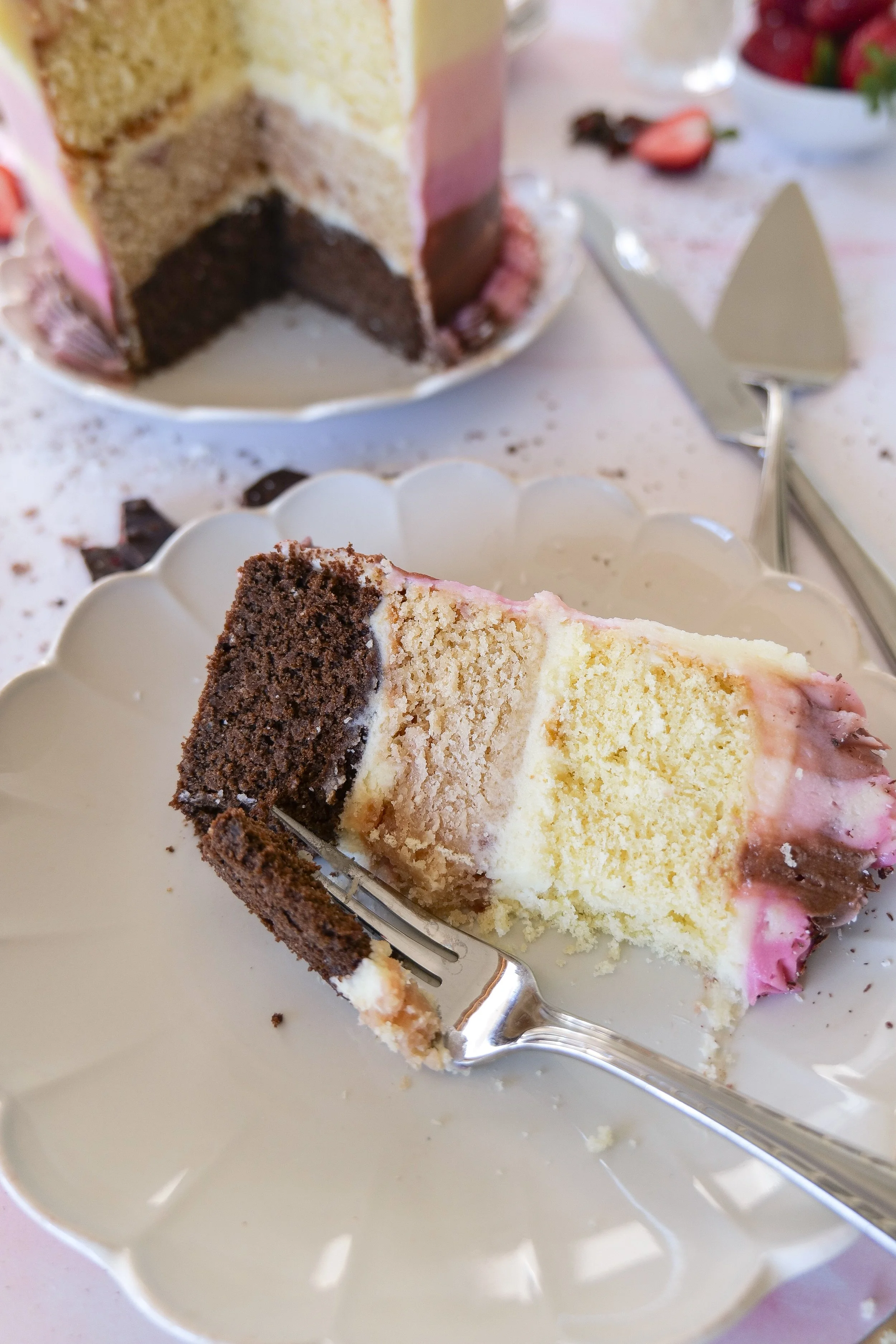 Neapolitan cake finished with rich cream cheese frosting and three colorful cake layers.