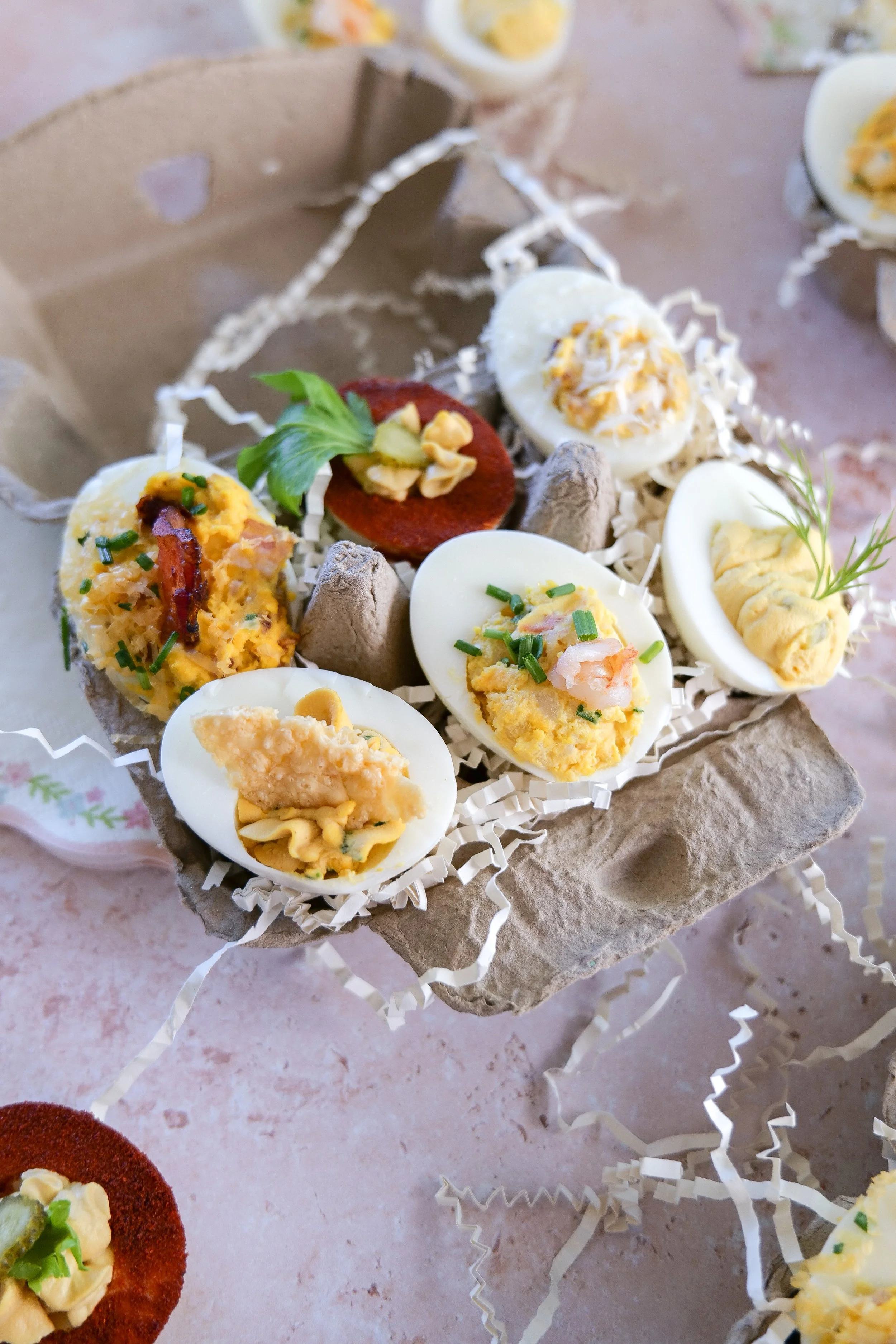 Carbonara deviled eggs garnished with parmesan cheese and bacon bits