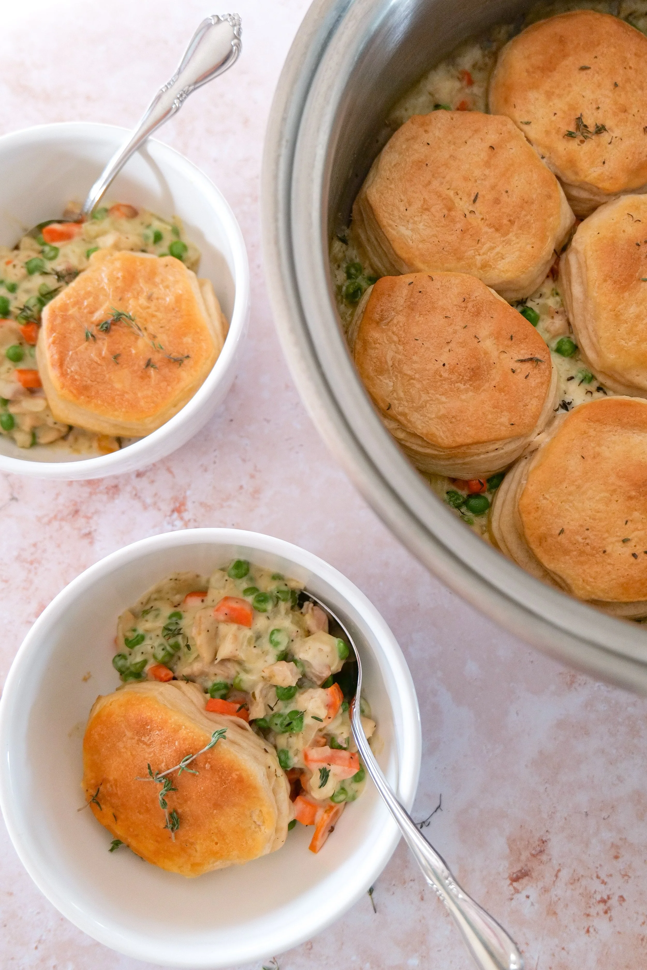 One-pan chicken pot pie recipe with tender chicken, vegetables, creamy sauce, and fluffy biscuit topping.