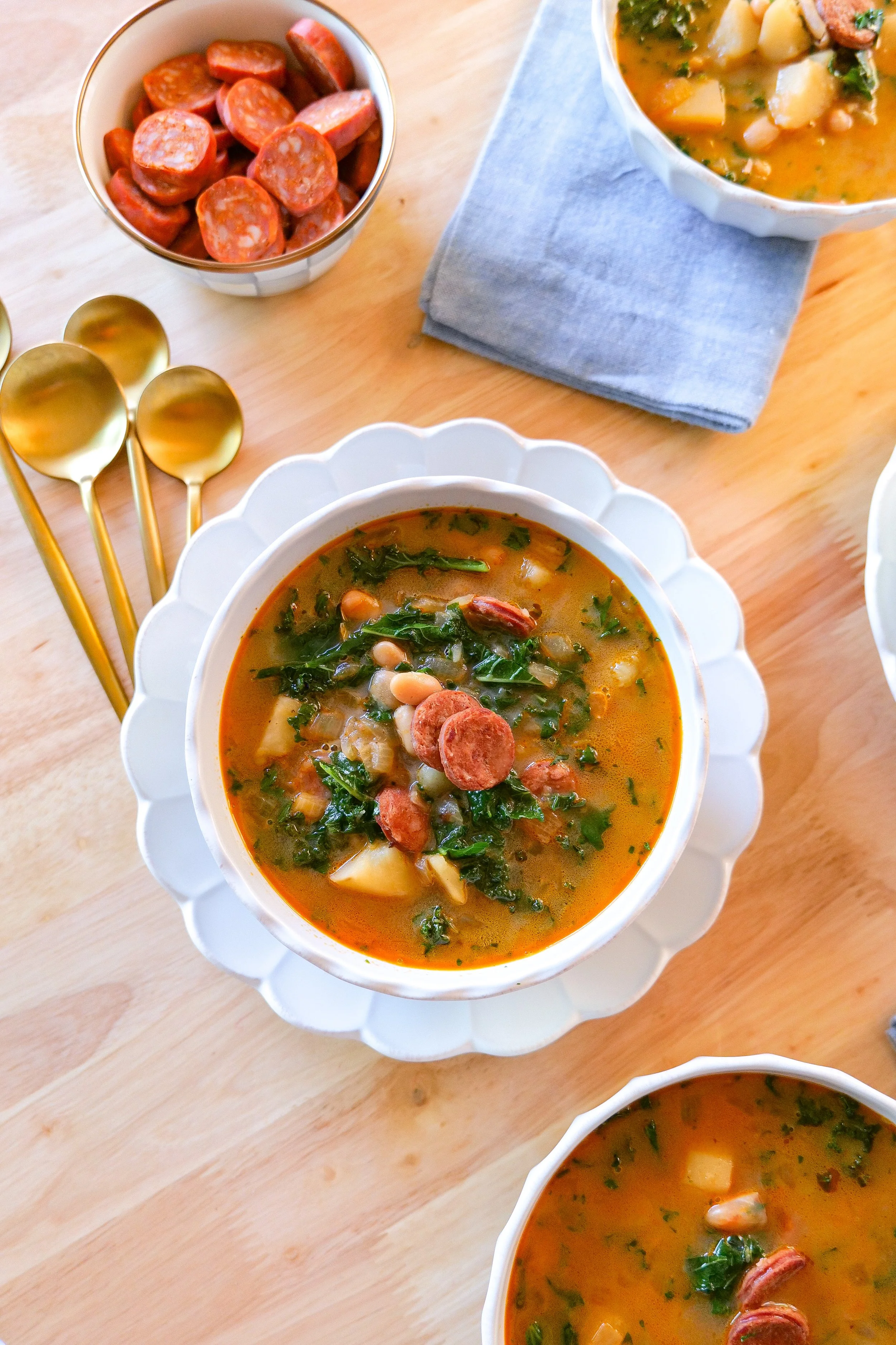Hearty linguiça and kale Portuguese soup with potatoes and white kidney beans.