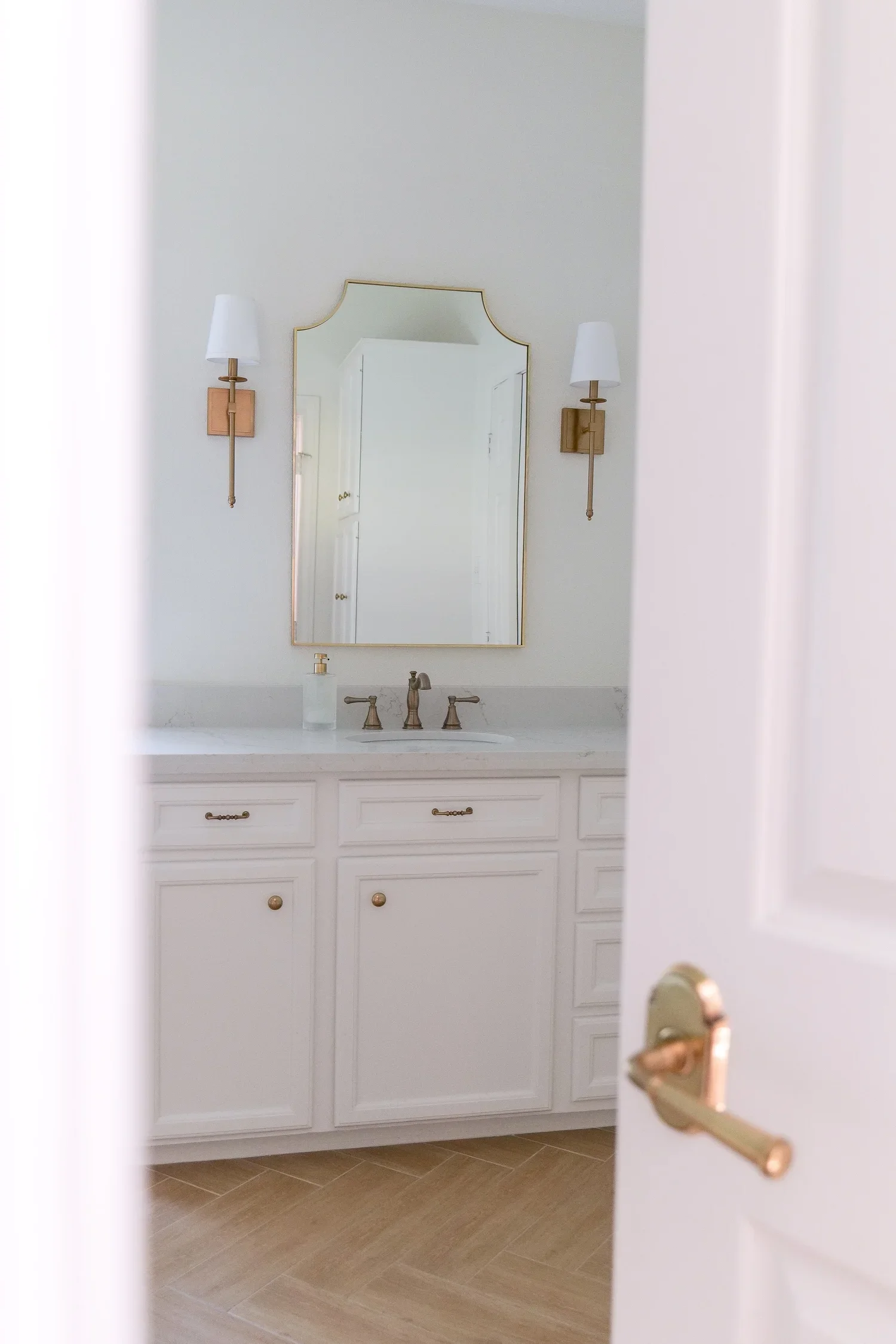 Before-and-after style home improvement featuring upgraded interior door knobs in a remodeled home.