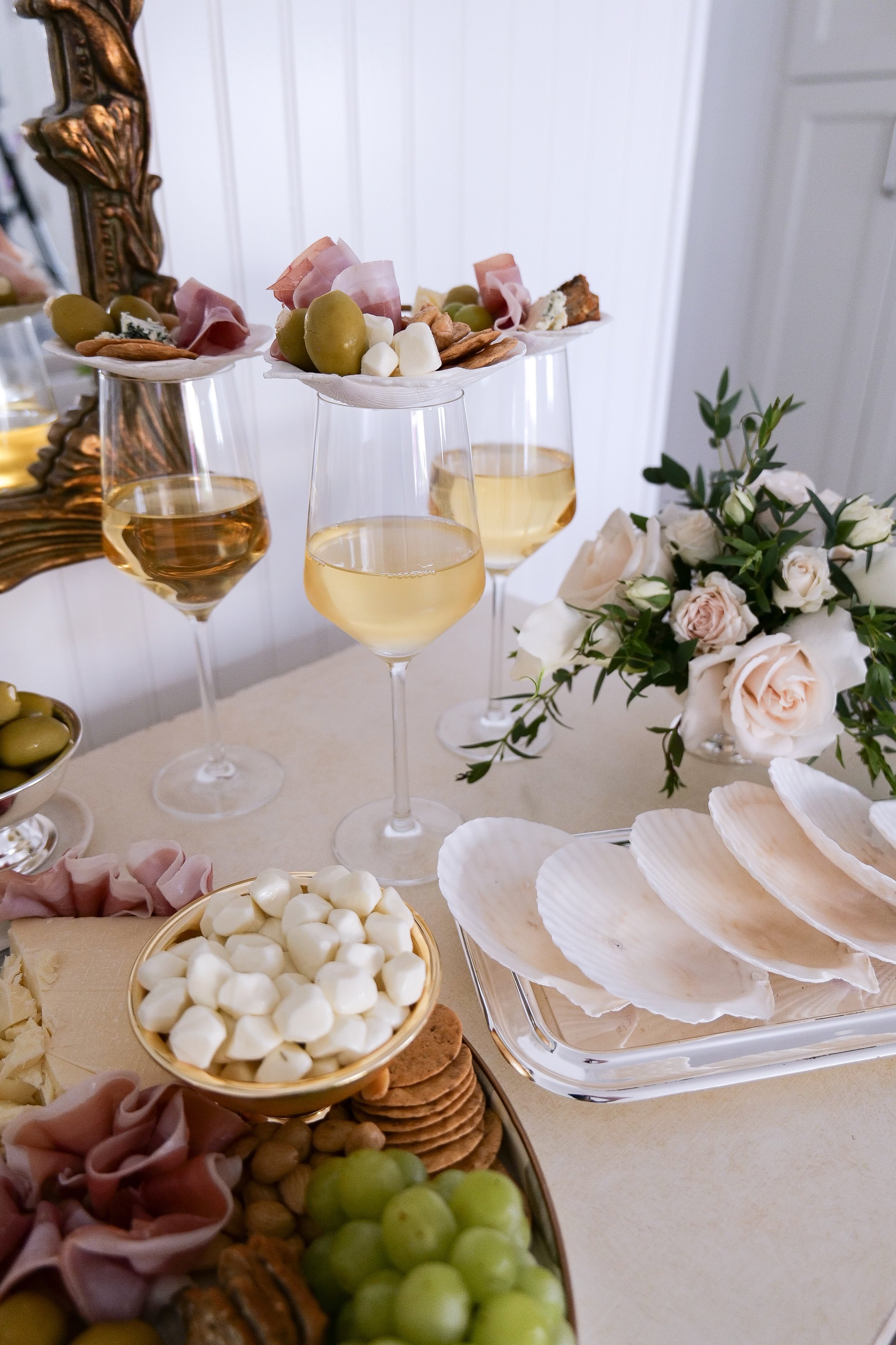 Elegant coastal entertaining setup with wine and grazing foods