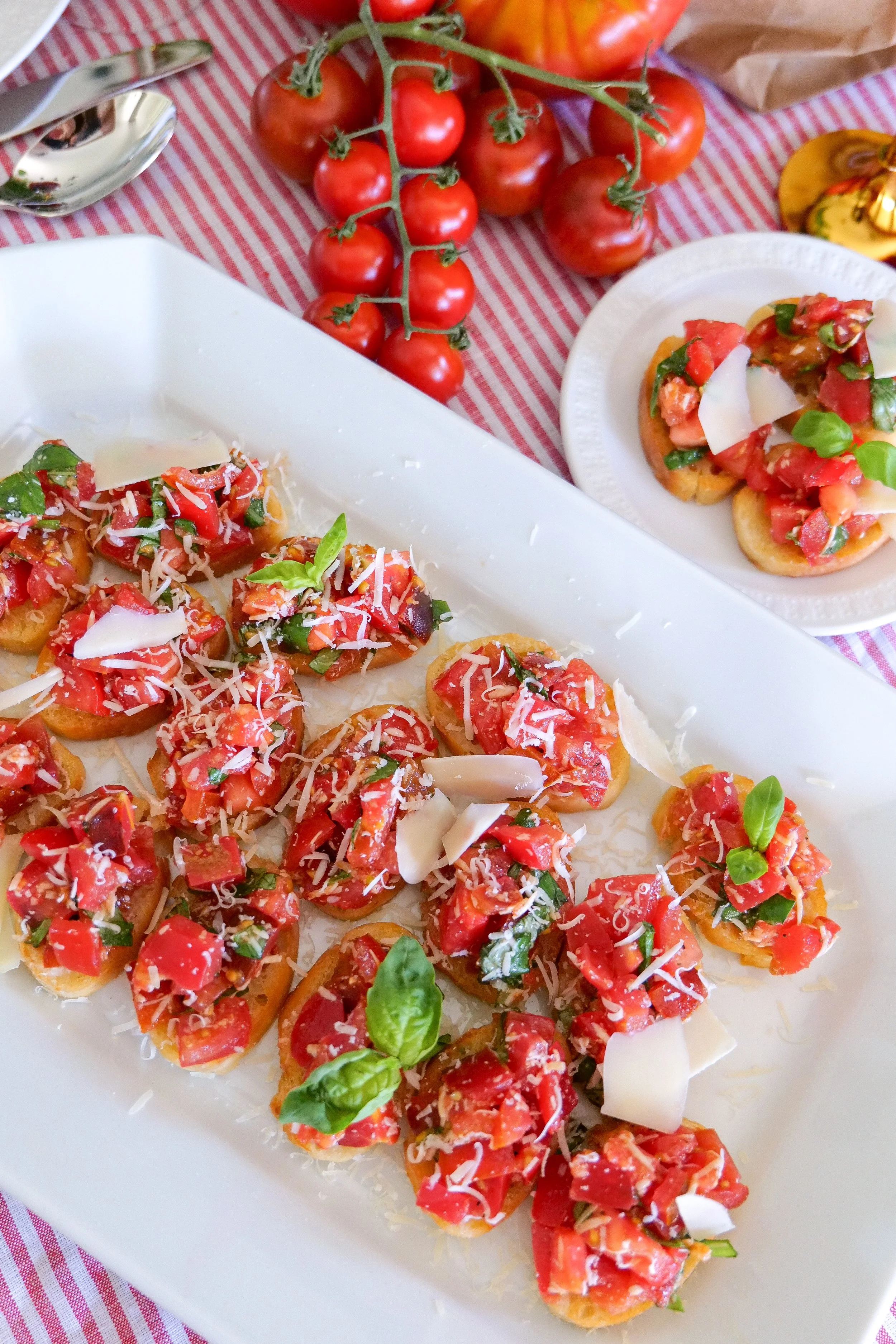 Tomato and basil bruschetta topped with Parmesan on slices of golden toasted bread