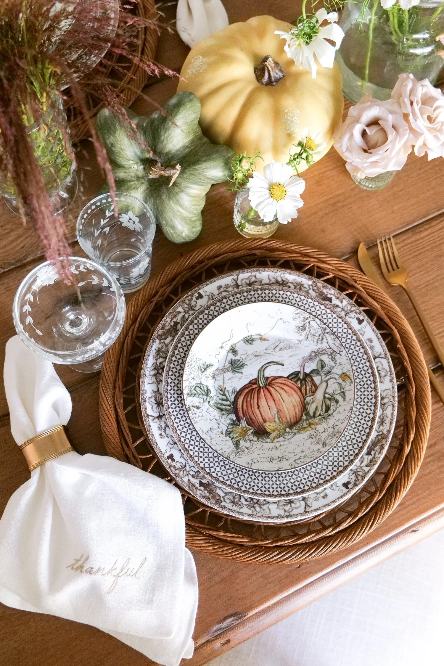 Pumpkins arranged around a rustic floral centerpiece