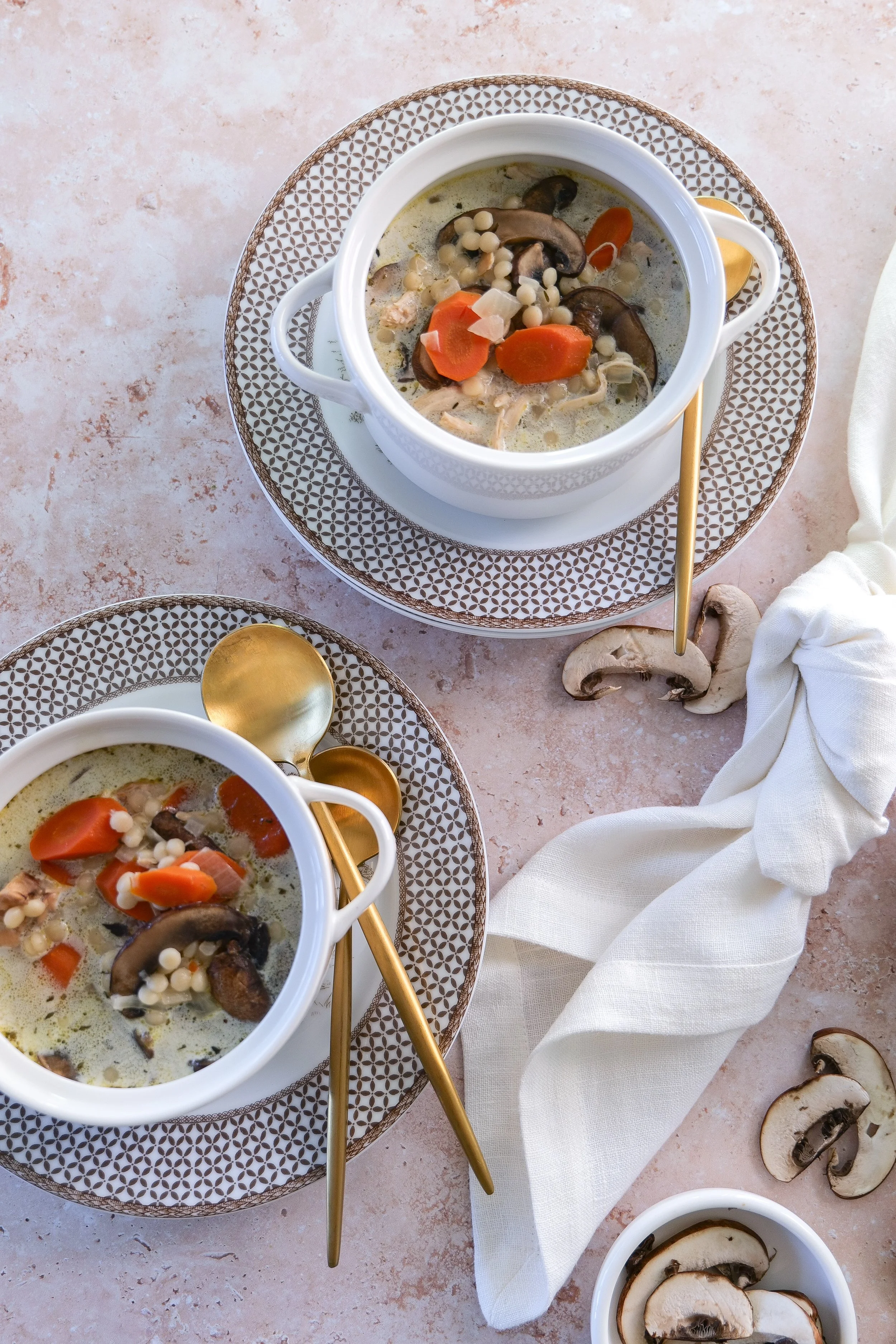 two bowls of chicken and mushroom couscous soup