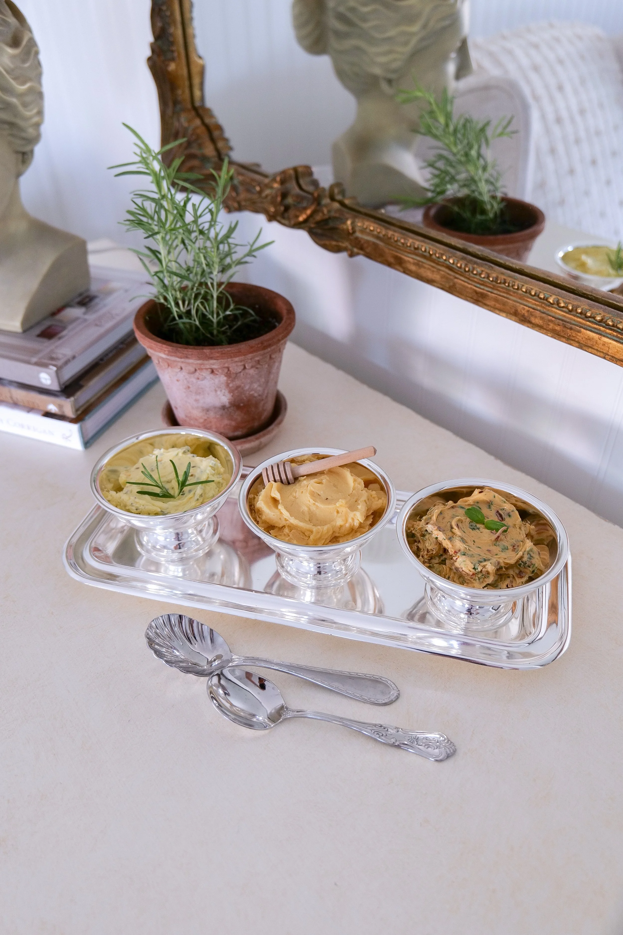 Assorted compound butter flavors in a small metal serving cup