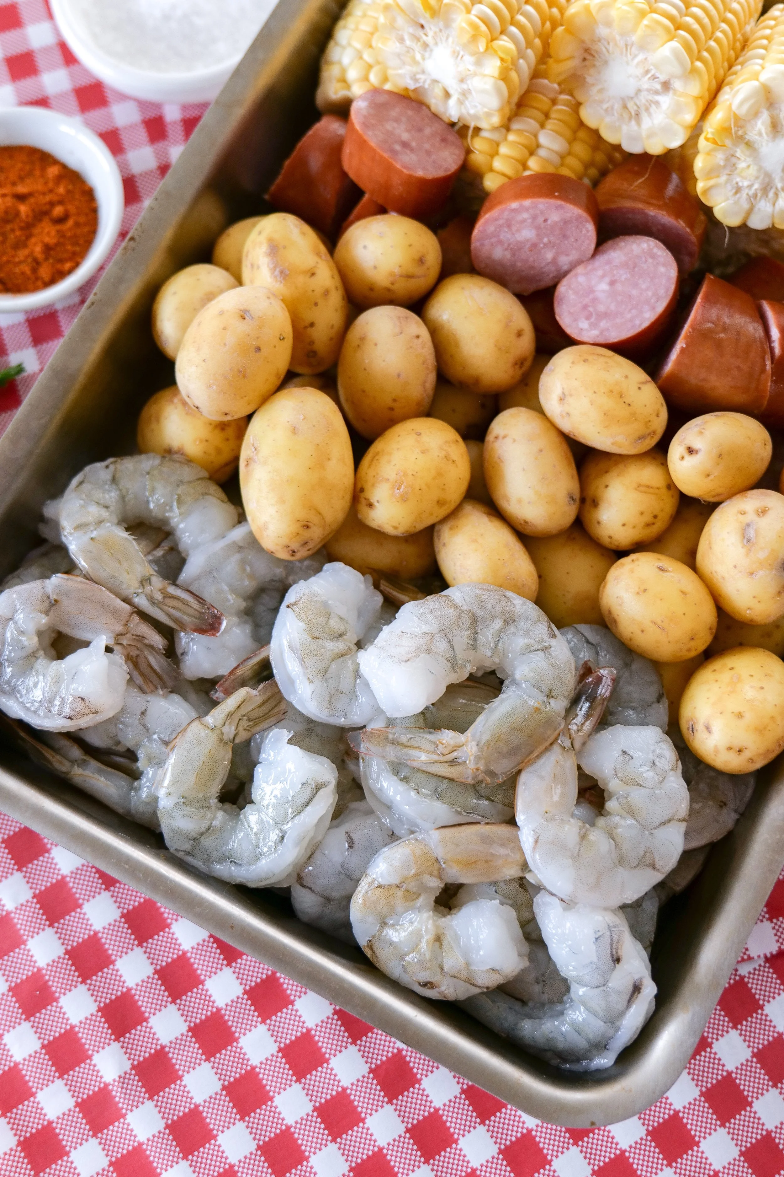 Homemade shrimp boil cooking in an 8-quart stainless steel stock pot.