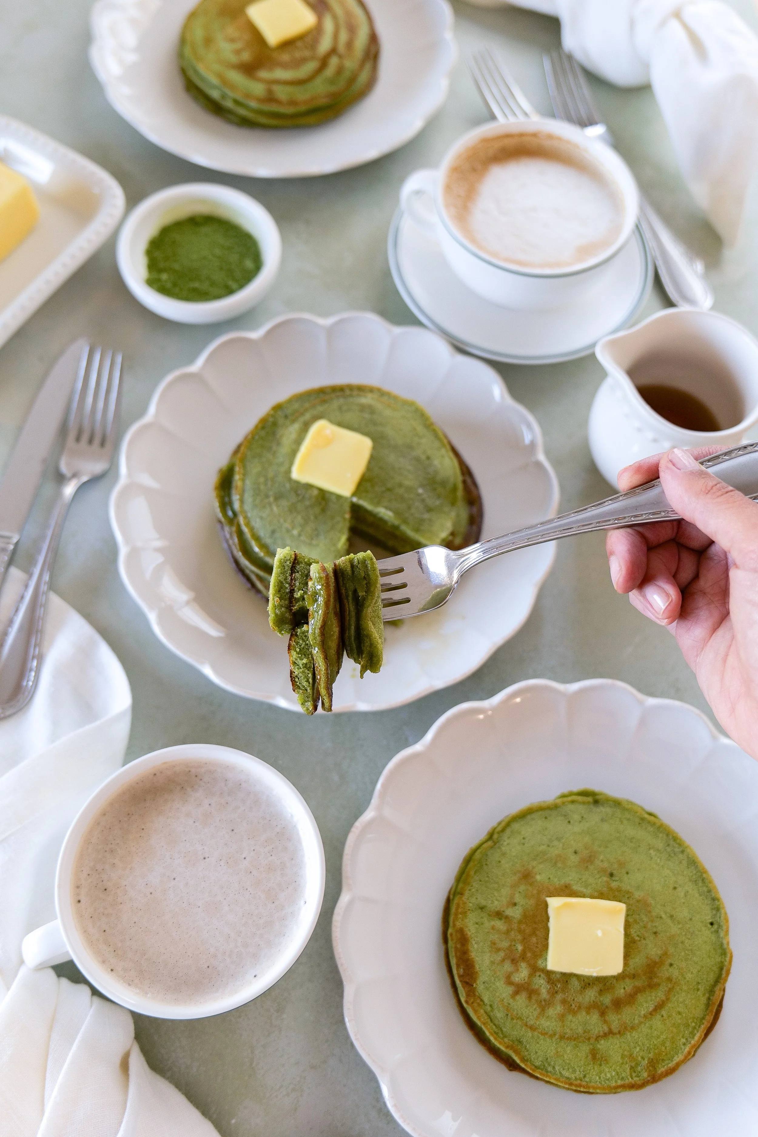 Fluffy matcha sourdough discard pancakes served with maple syrup and fresh berries for an easy zero-waste breakfast recipe.