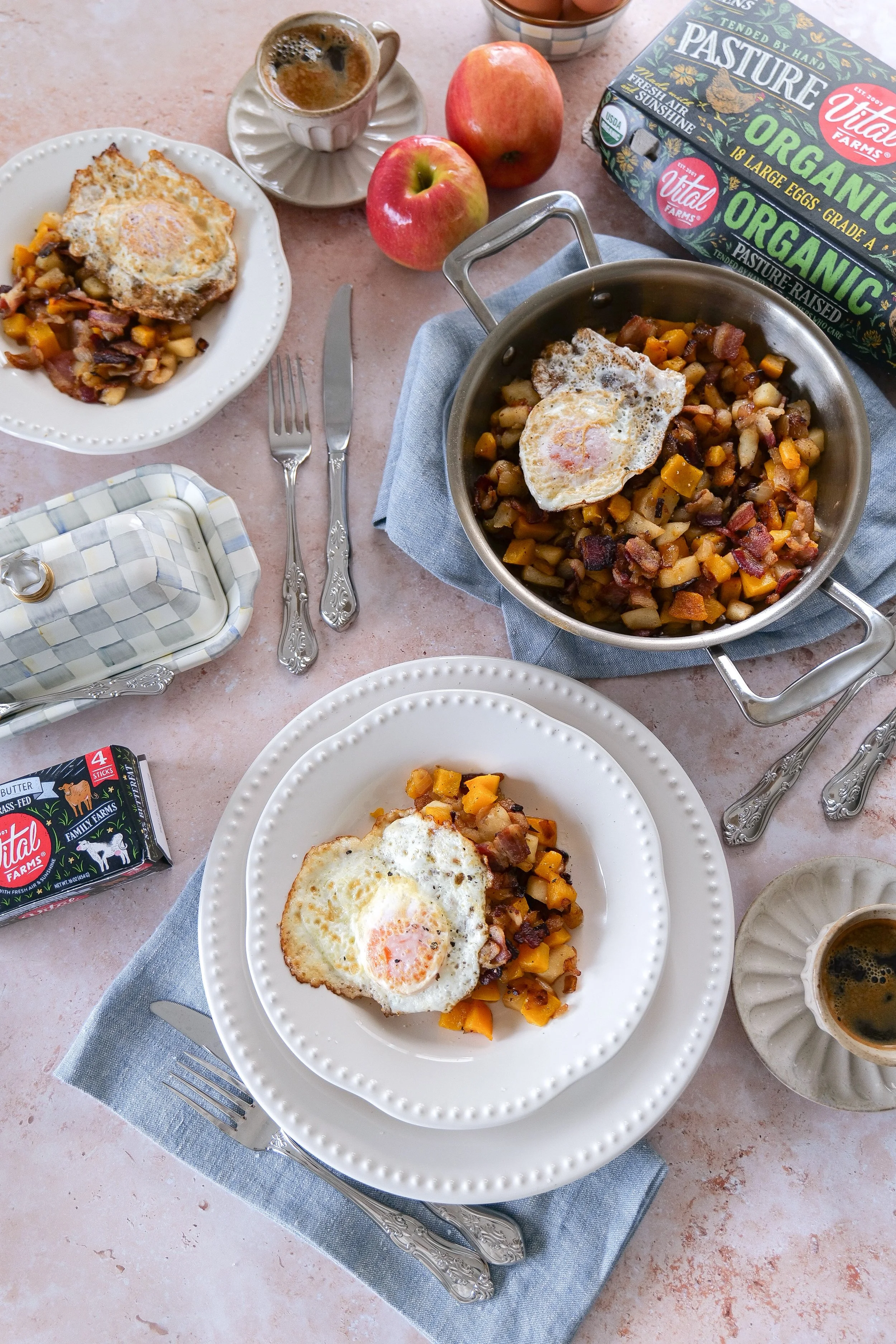 Easy butternut squash breakfast hash with apples and bacon topped with fried eggs.