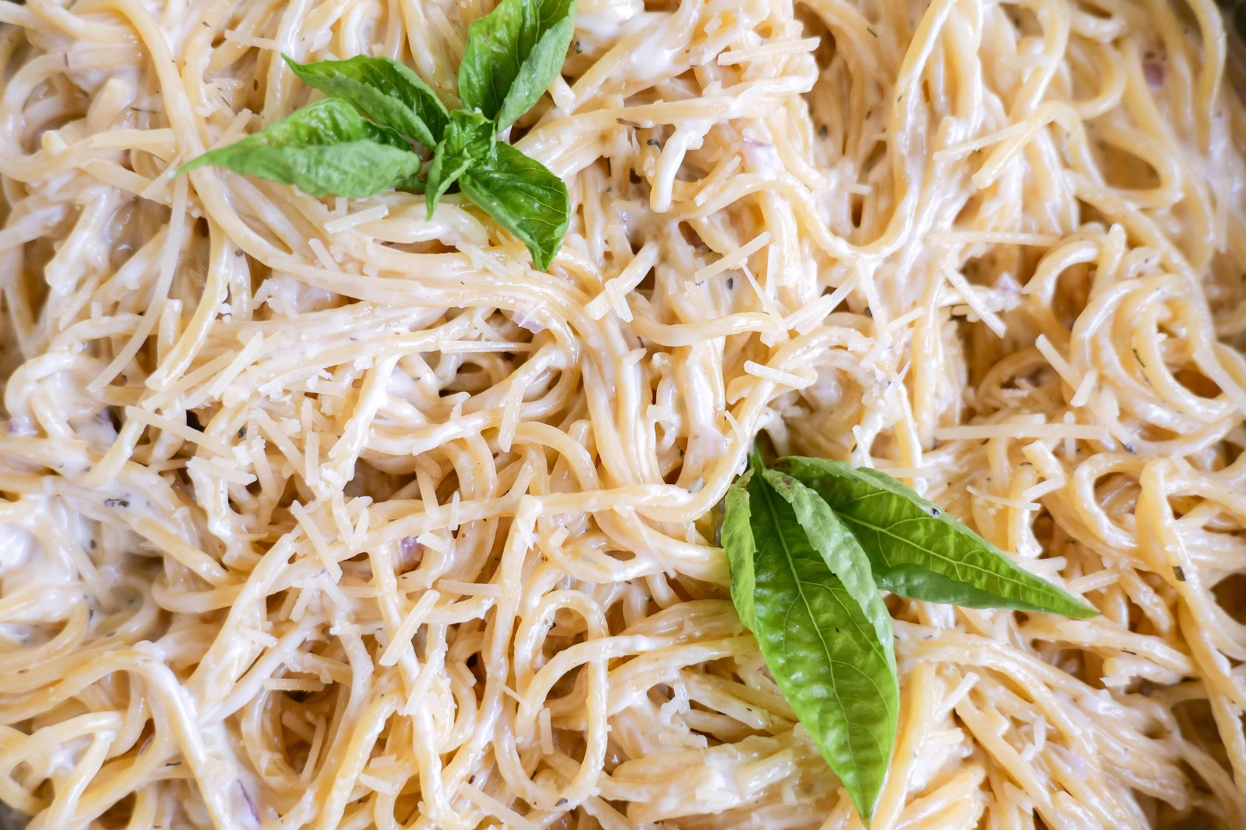 White sauce pasta finished with grated Parmesan and freshly ground black pepper.