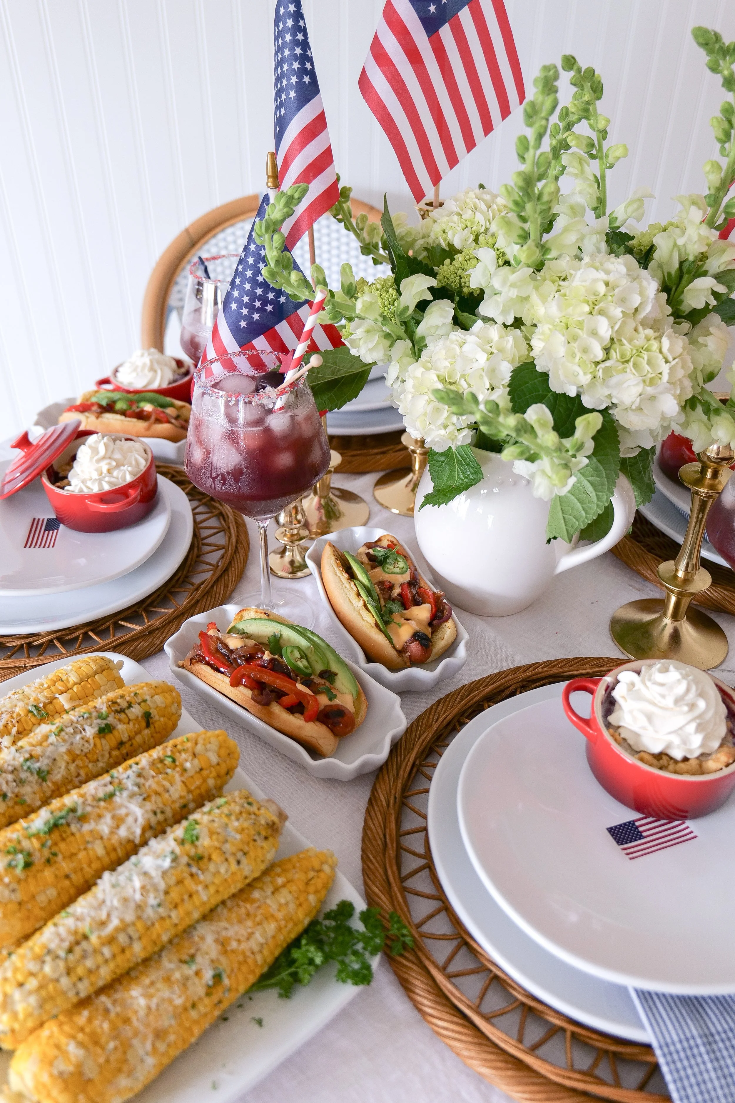 Summer hosting table featuring corn on the cob and seasonal decor