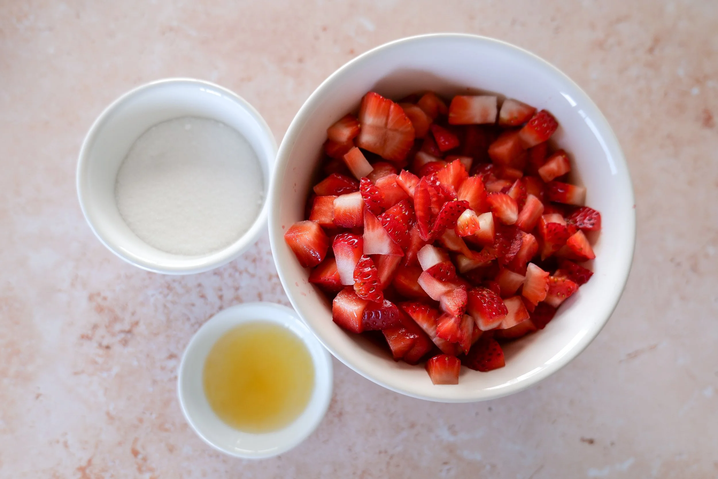 diced strawberries, white sugar and lemon juice