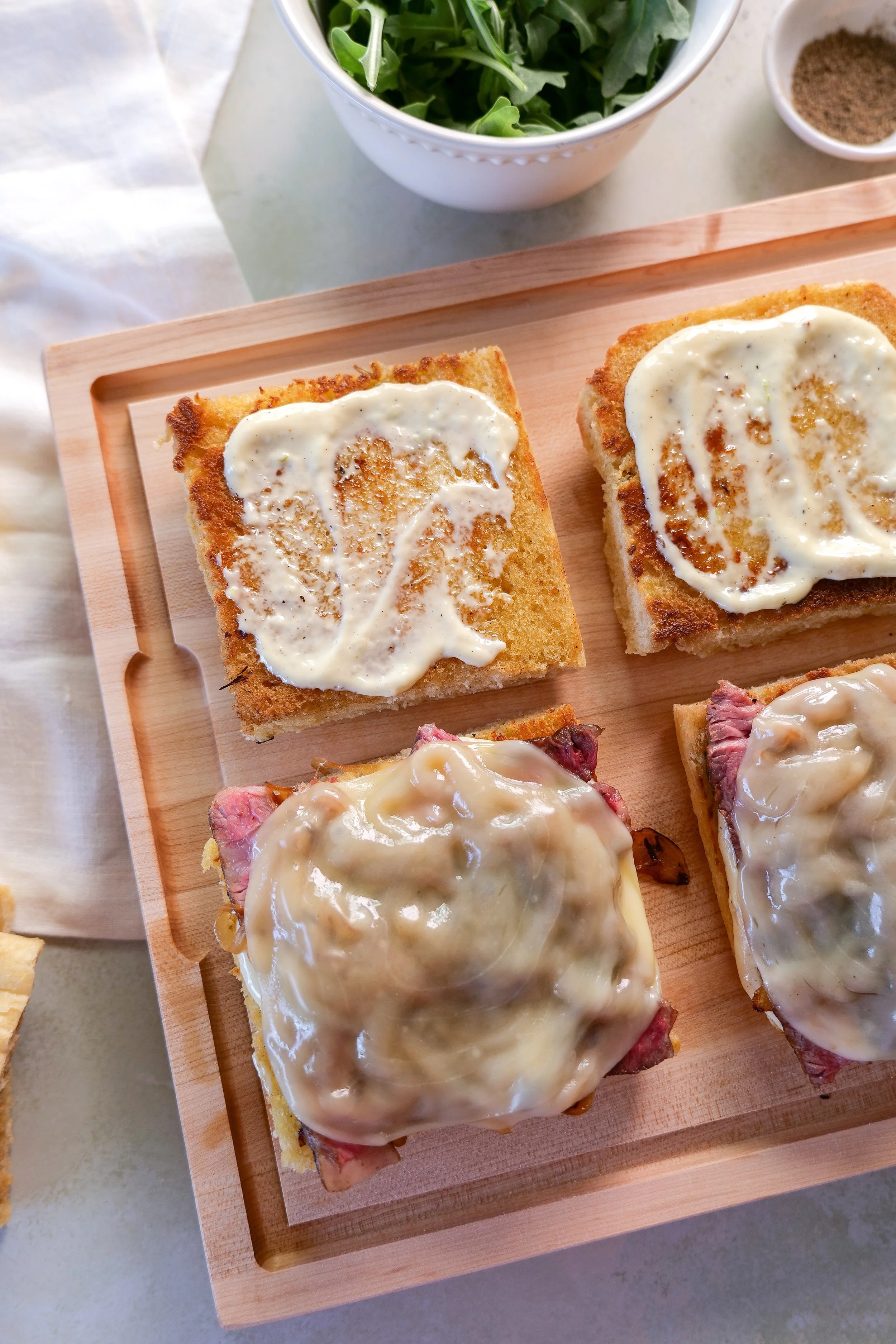 Rested ribeye sliced thinly against the grain for a tender steak focaccia sandwich.
