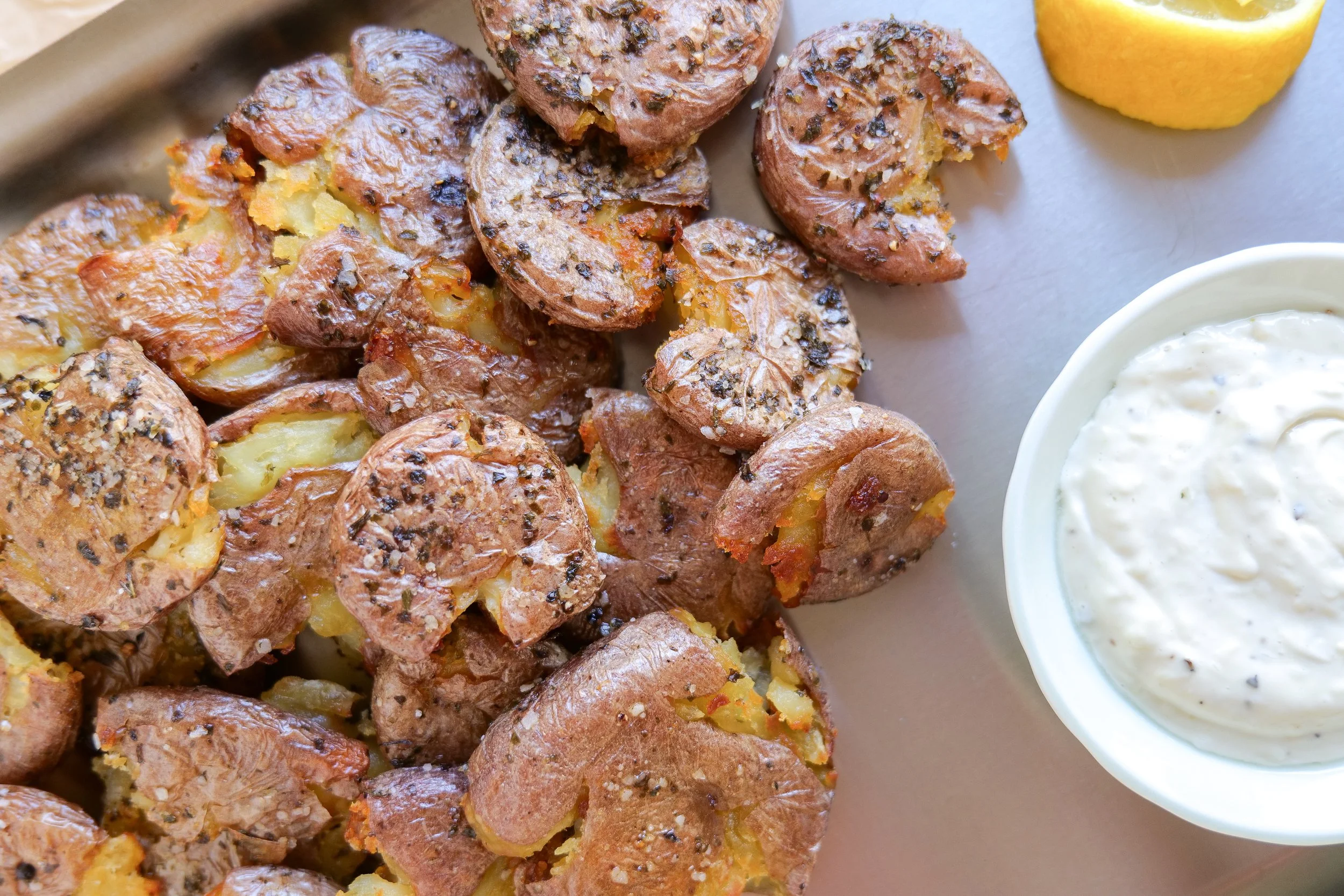 Golden oven-roasted smashed red potatoes with crispy edges and parsley