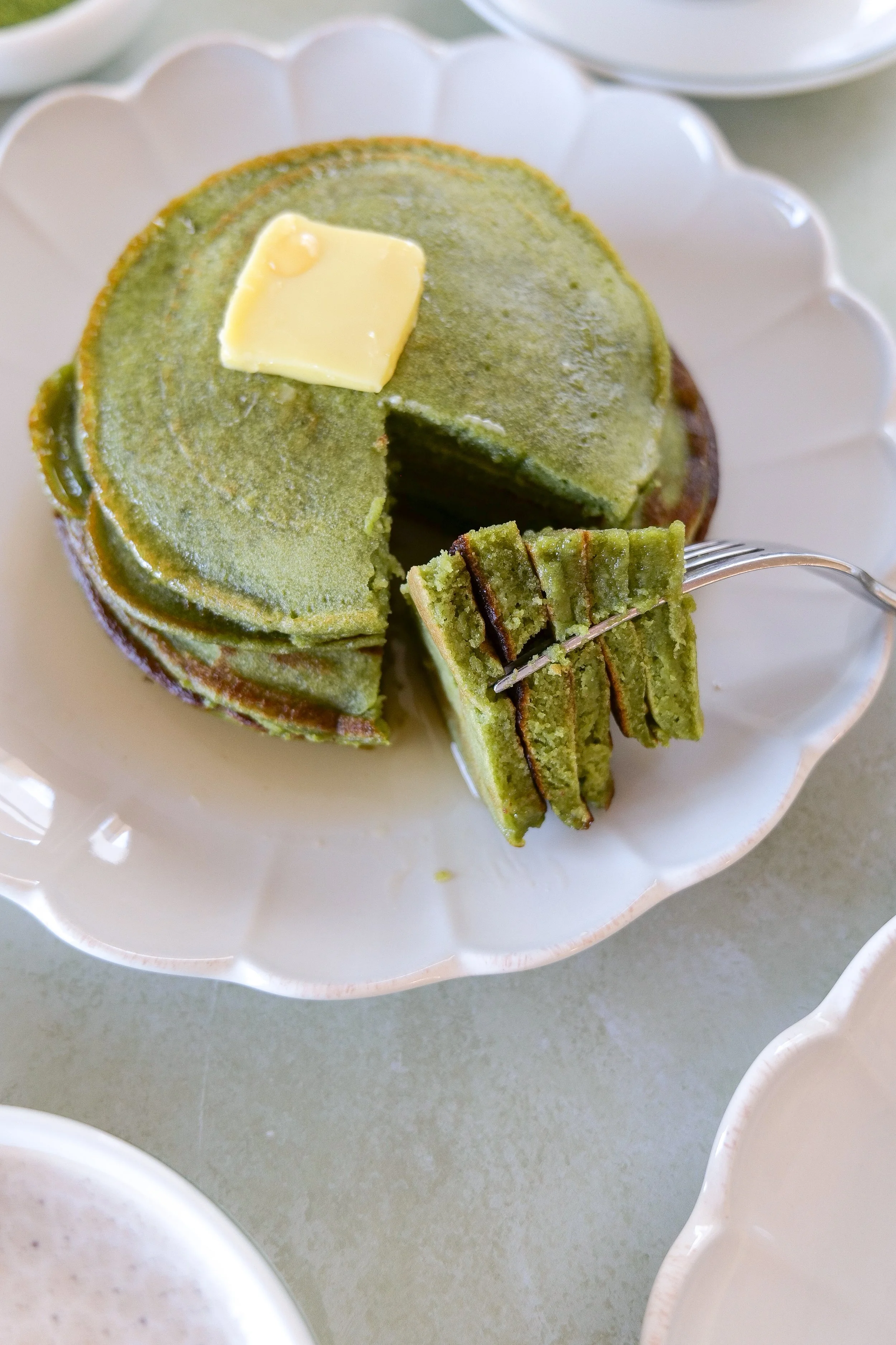 Tall stack of vibrant green sourdough discard matcha pancakes