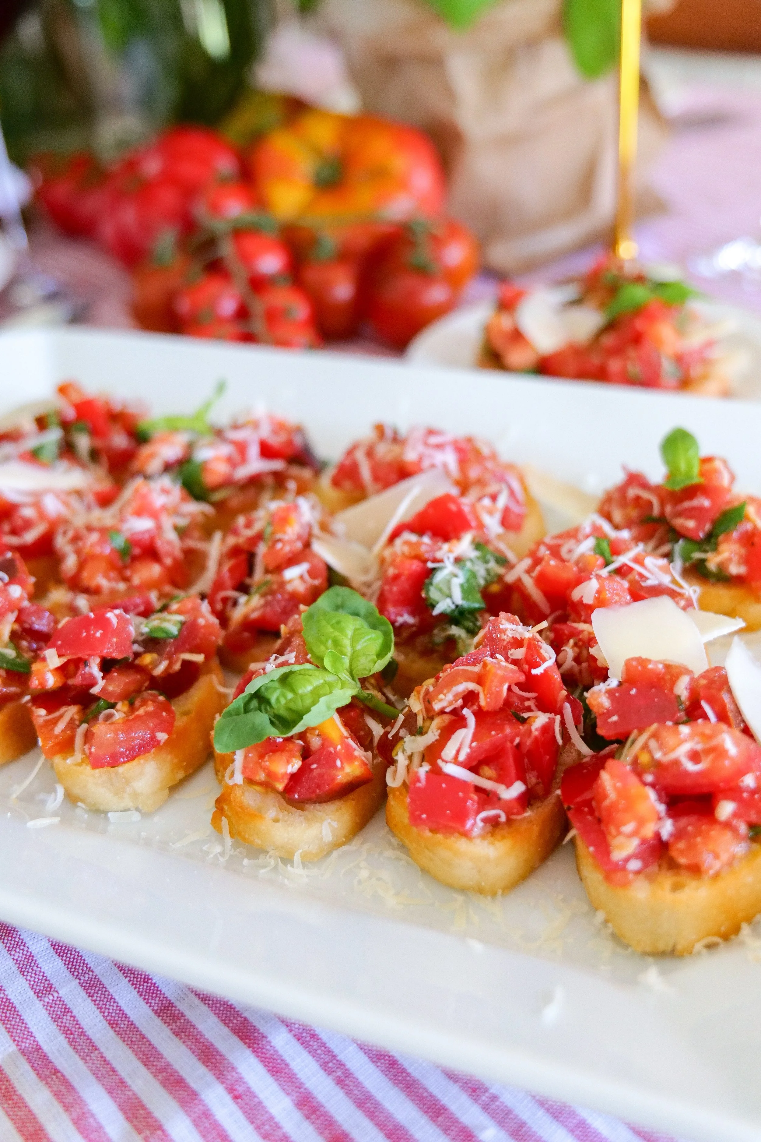 Homemade bruschetta with ripe tomatoes, fresh basil and shaved Parmesan