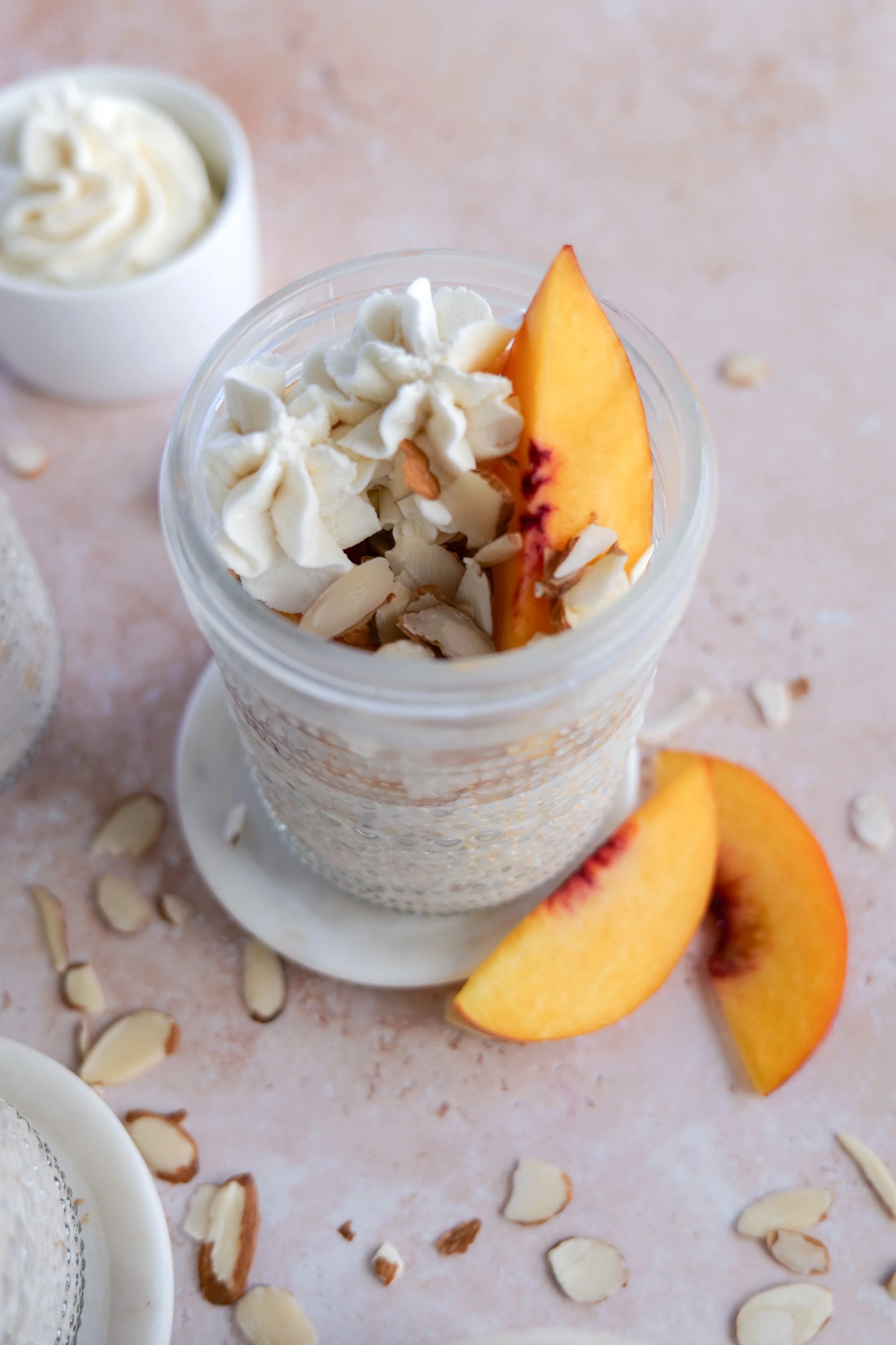 Peach Cobbler Overnight Oats divided into glass jars for meal prep.