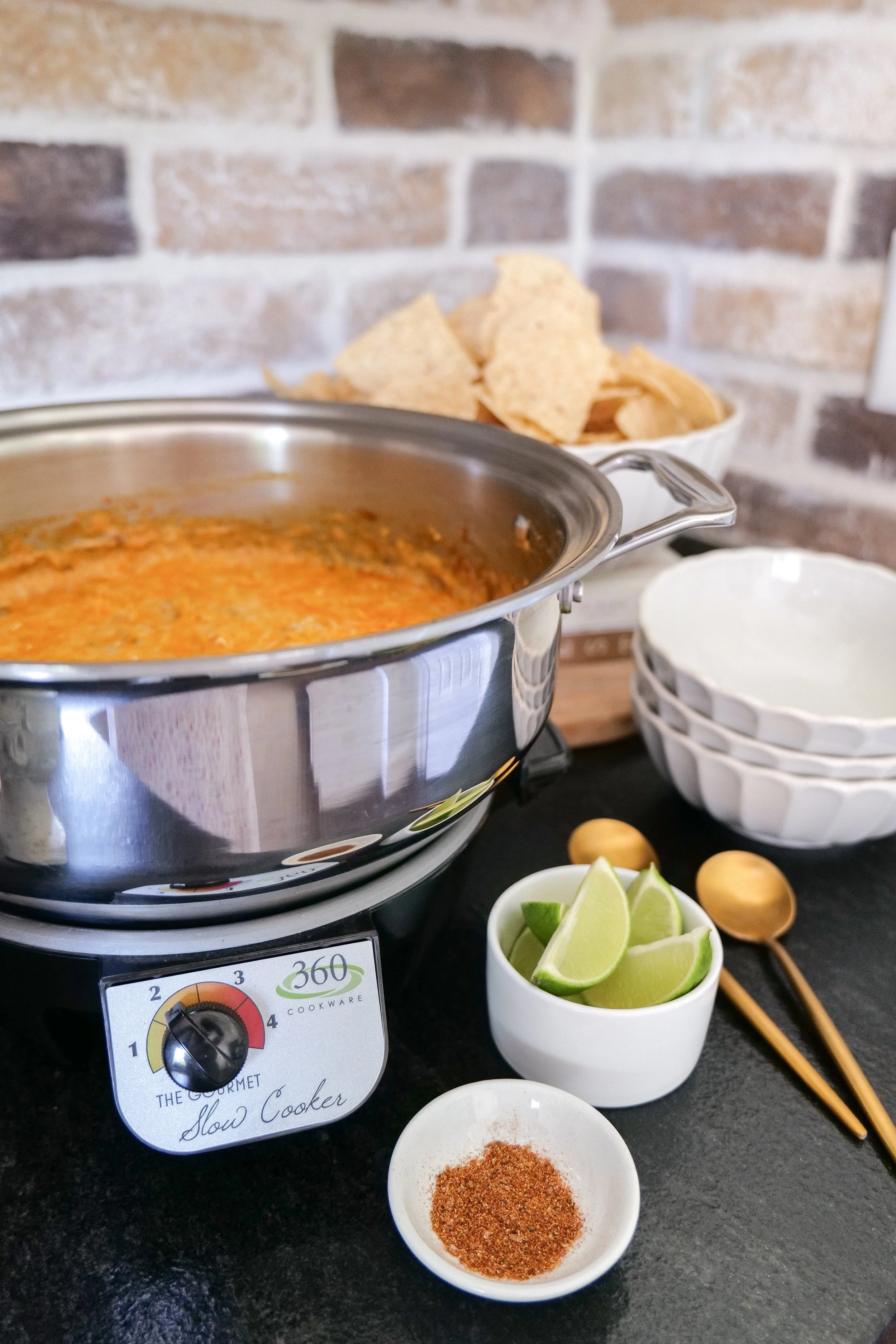 Warm chicken enchilada dip with black beans and cheese for an easy game day appetizer.