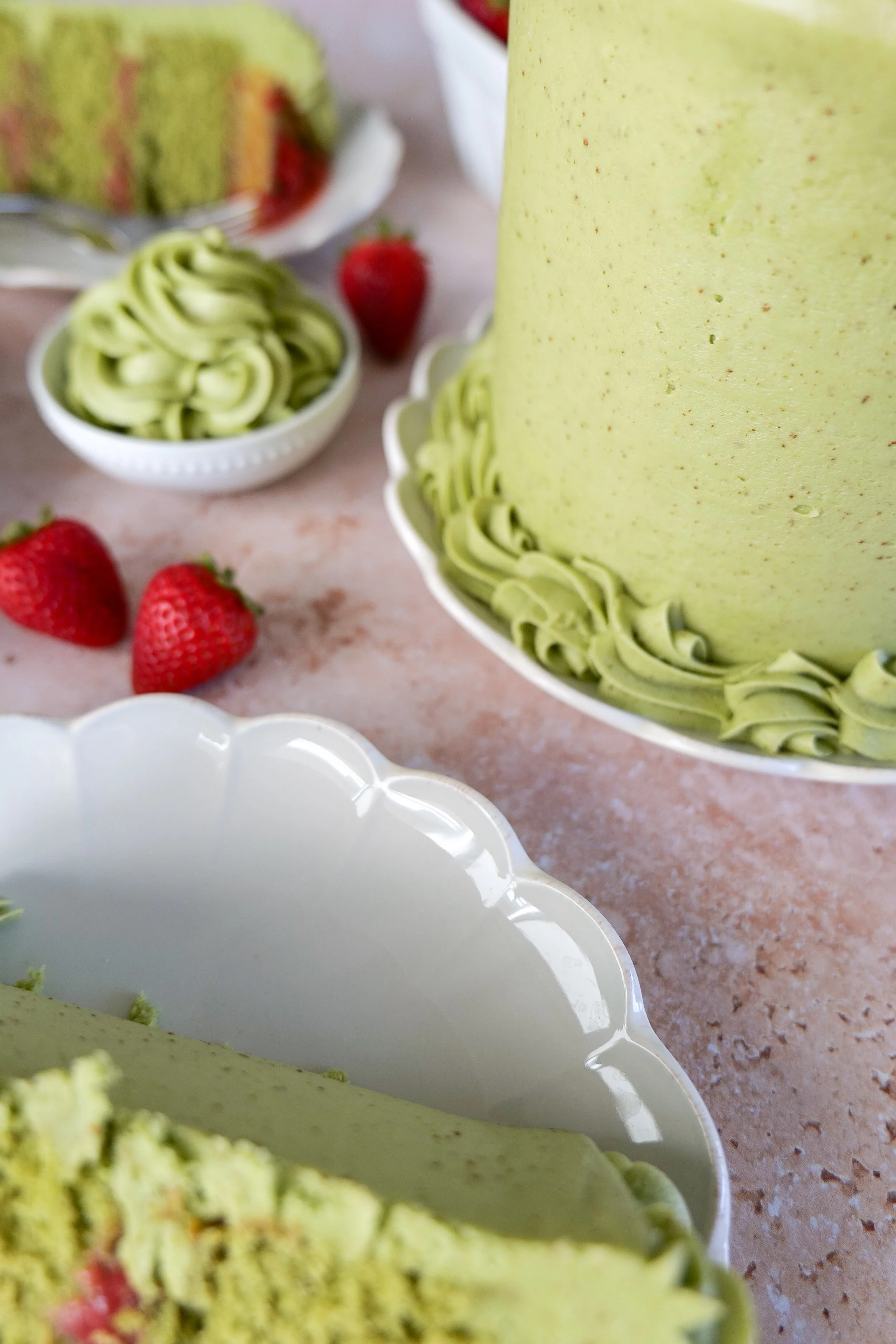 Soft matcha strawberry with creamy frosting and strawberries
