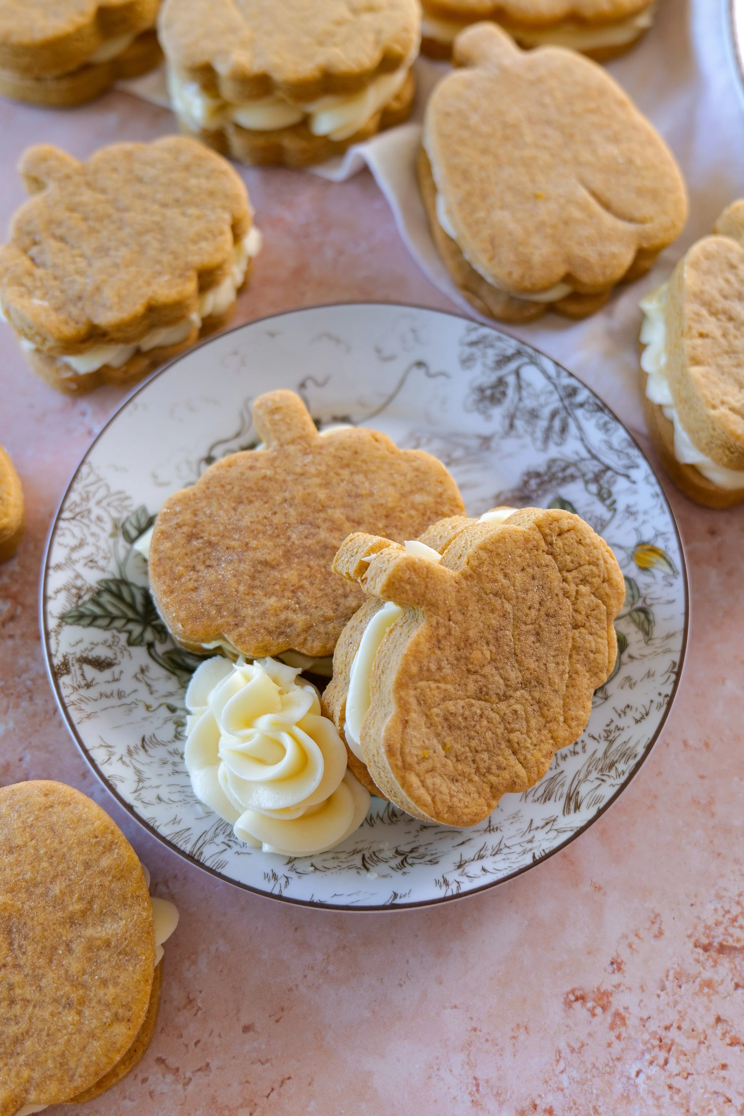 Cream cheese filling peeking between two soft pumpkin cookies