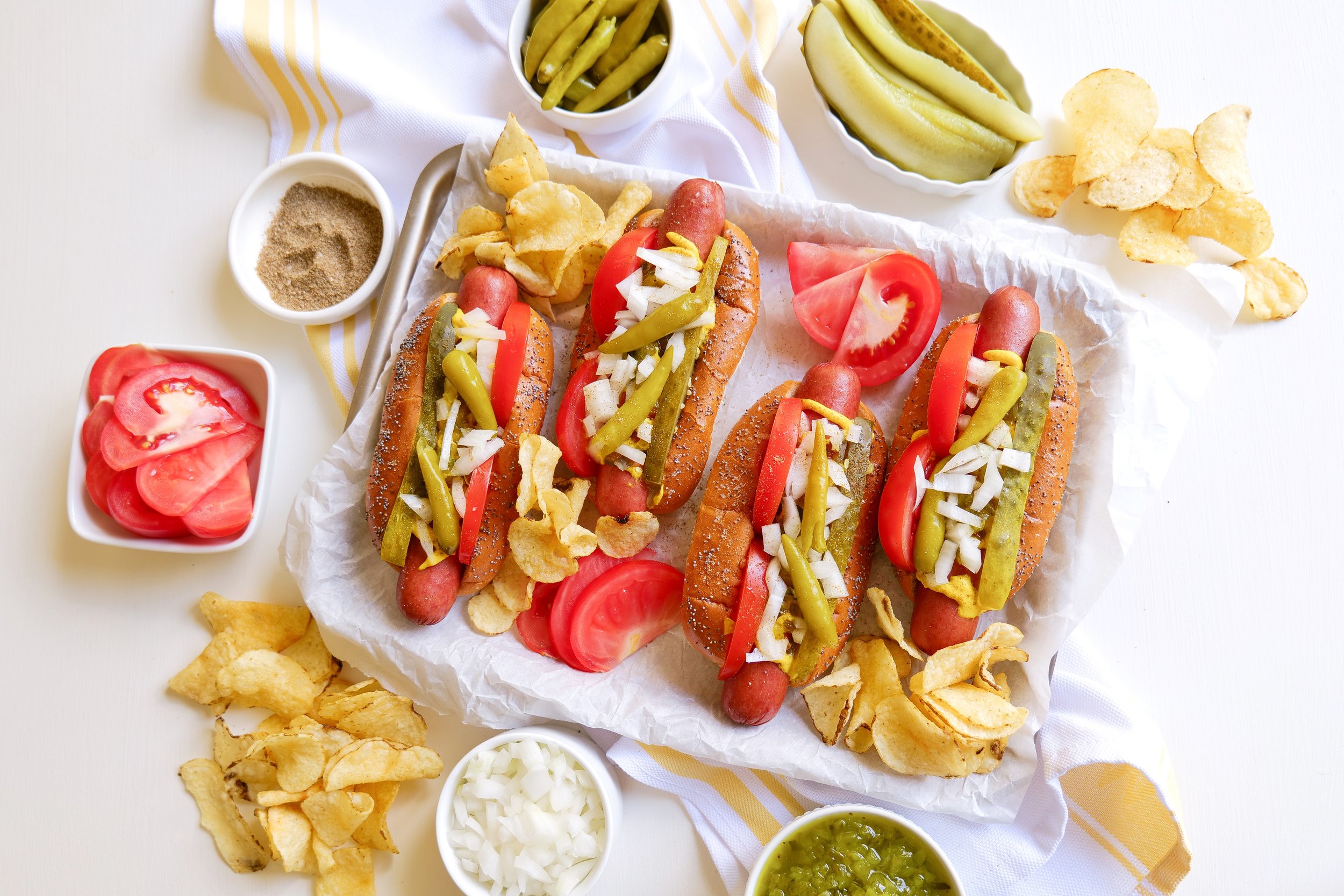 Chicago style hot dogs served for a summer cookout with classic toppings and chips.