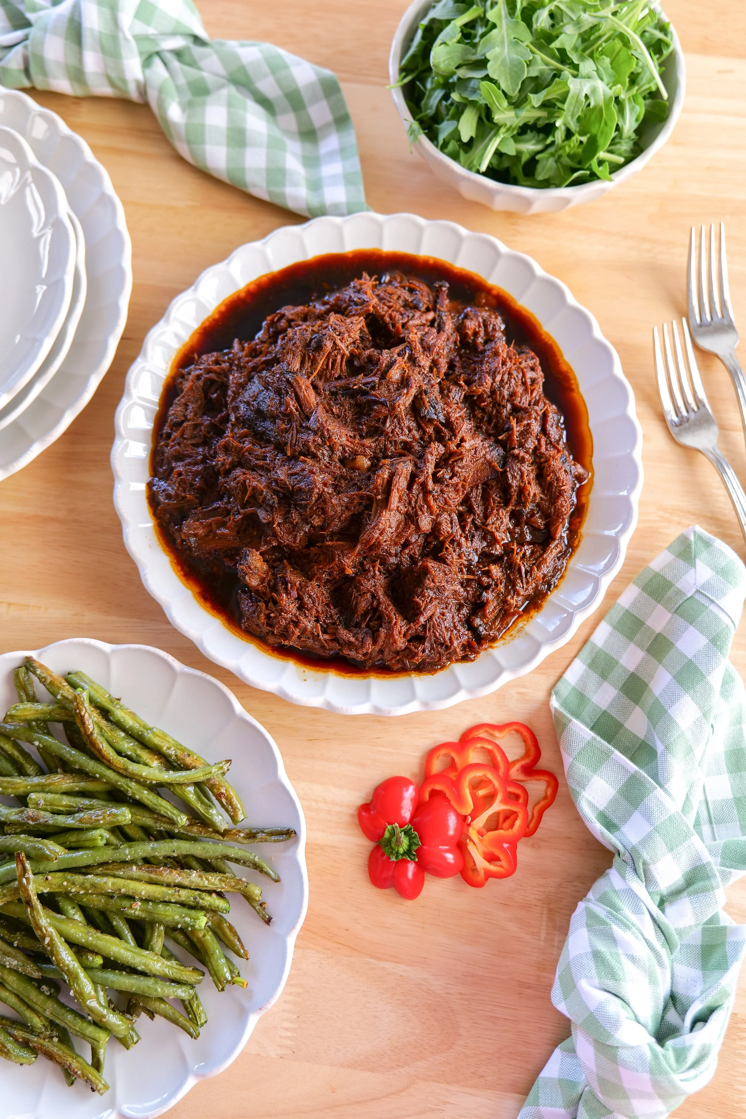 Tender BBQ brisket made in the slow cooker and served warm with extra sauce on the side.