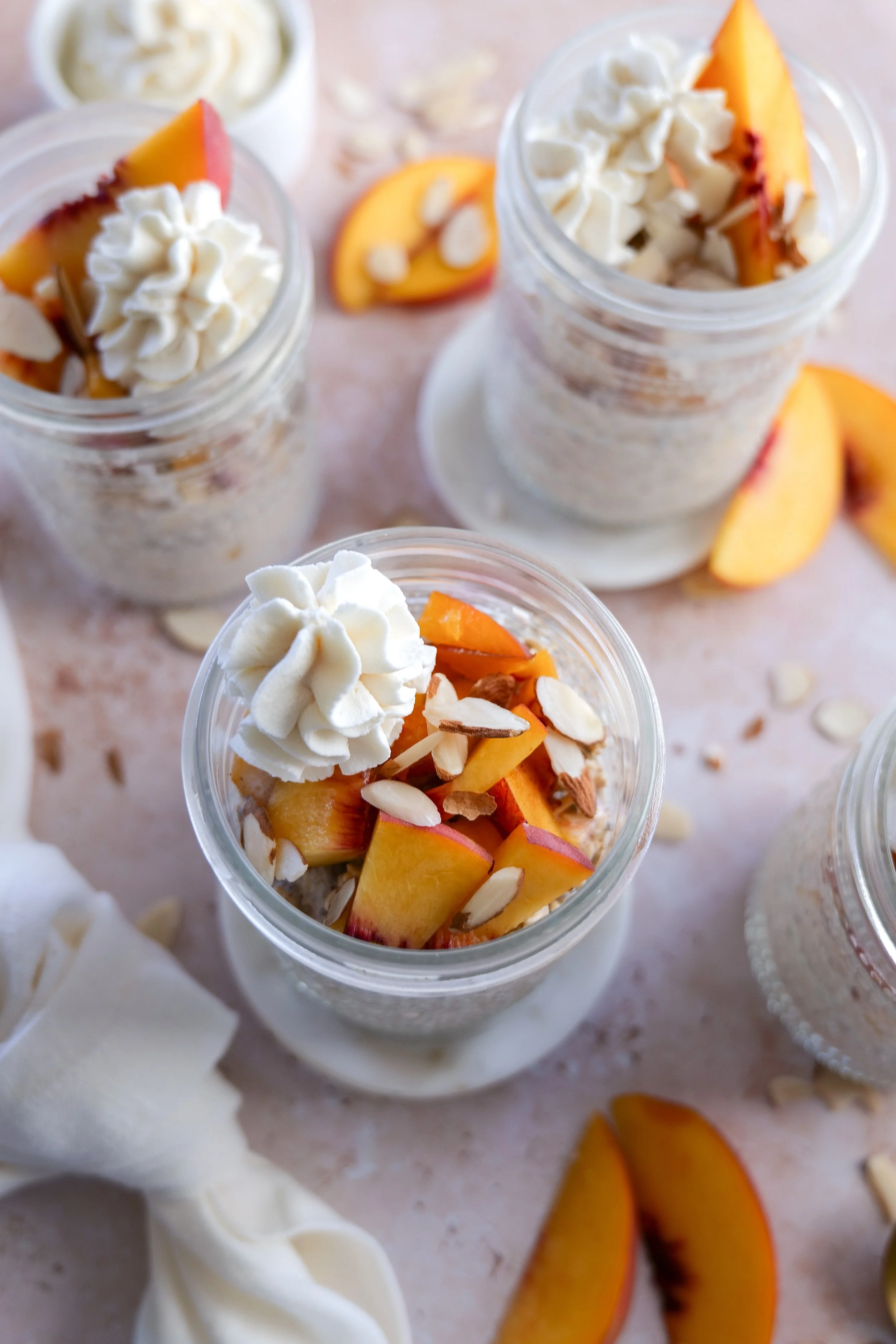 Peach Cobbler Overnight Oats garnished with toasted pecans and cinnamon.