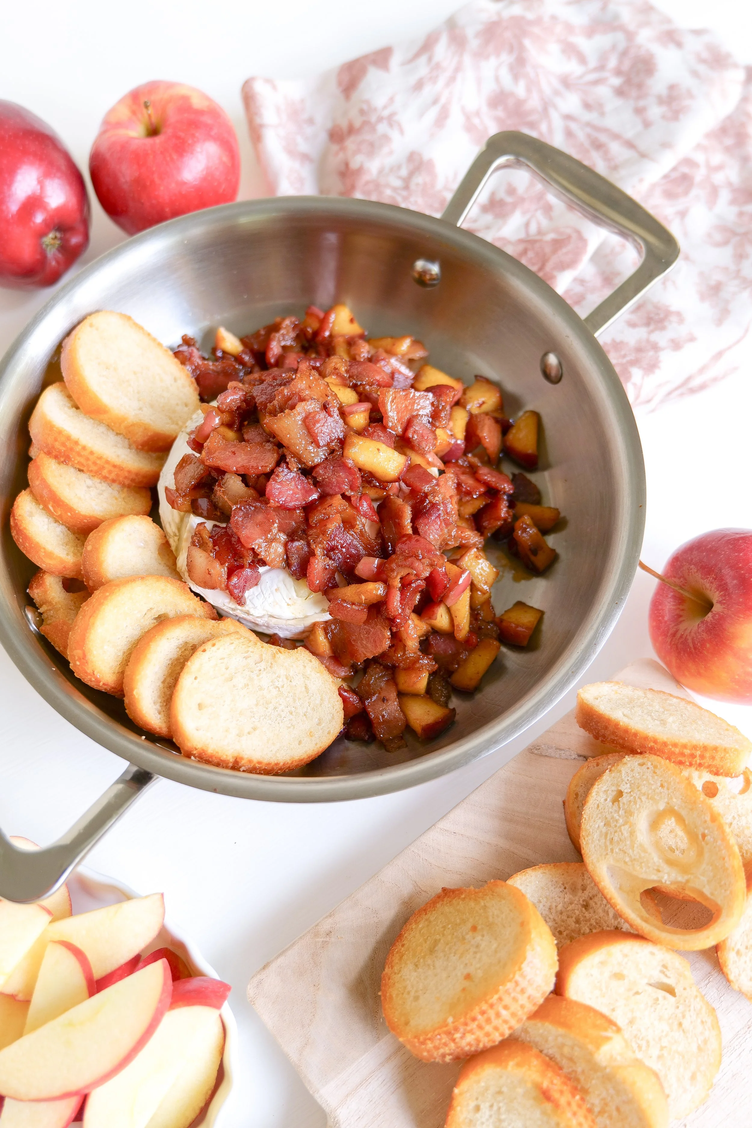 Easy fall cheese appetizer featuring baked brie with bacon and apples.