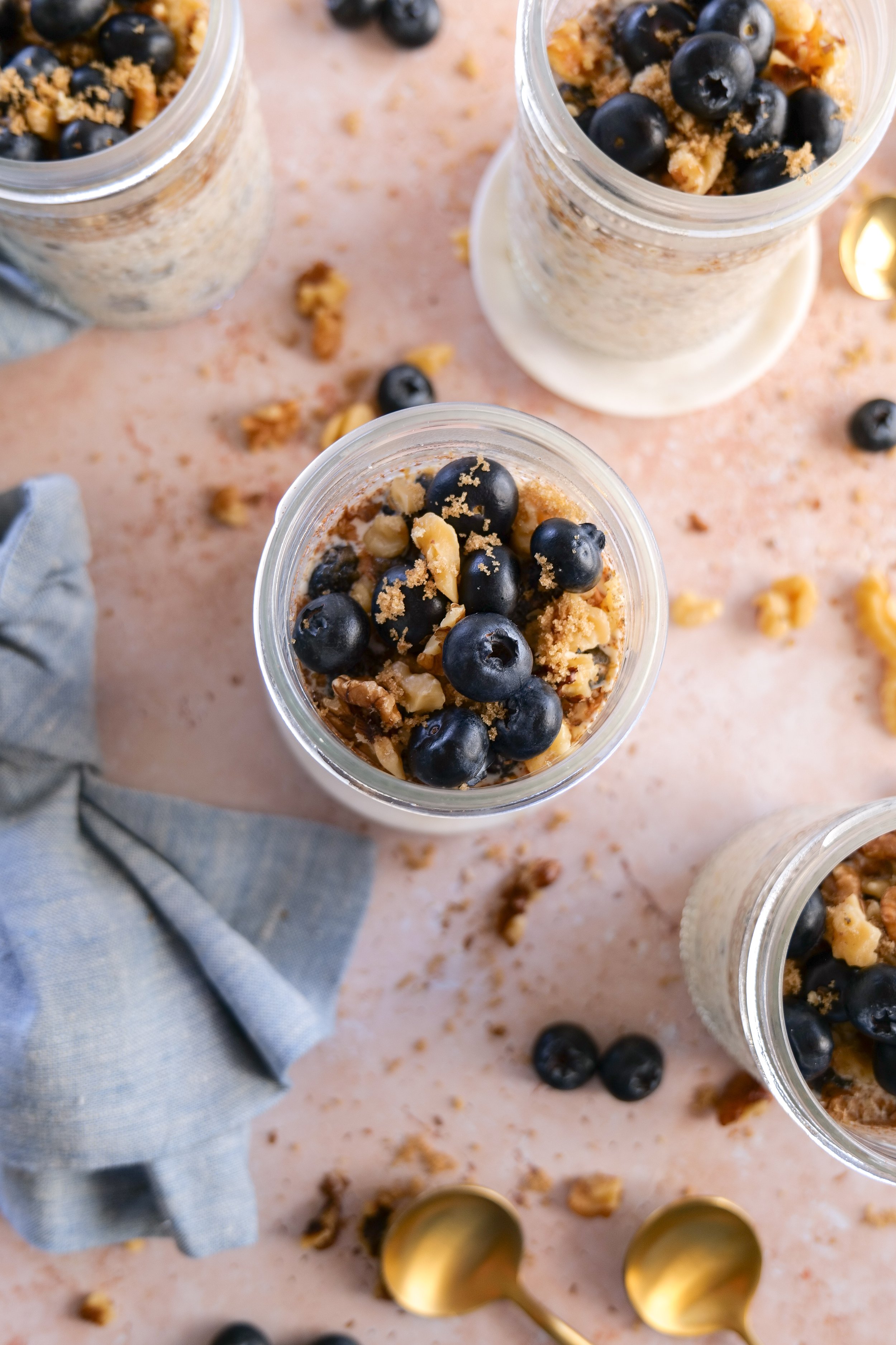 Blueberry Pie Overnight Oats portioned into glass jars for meal prep.