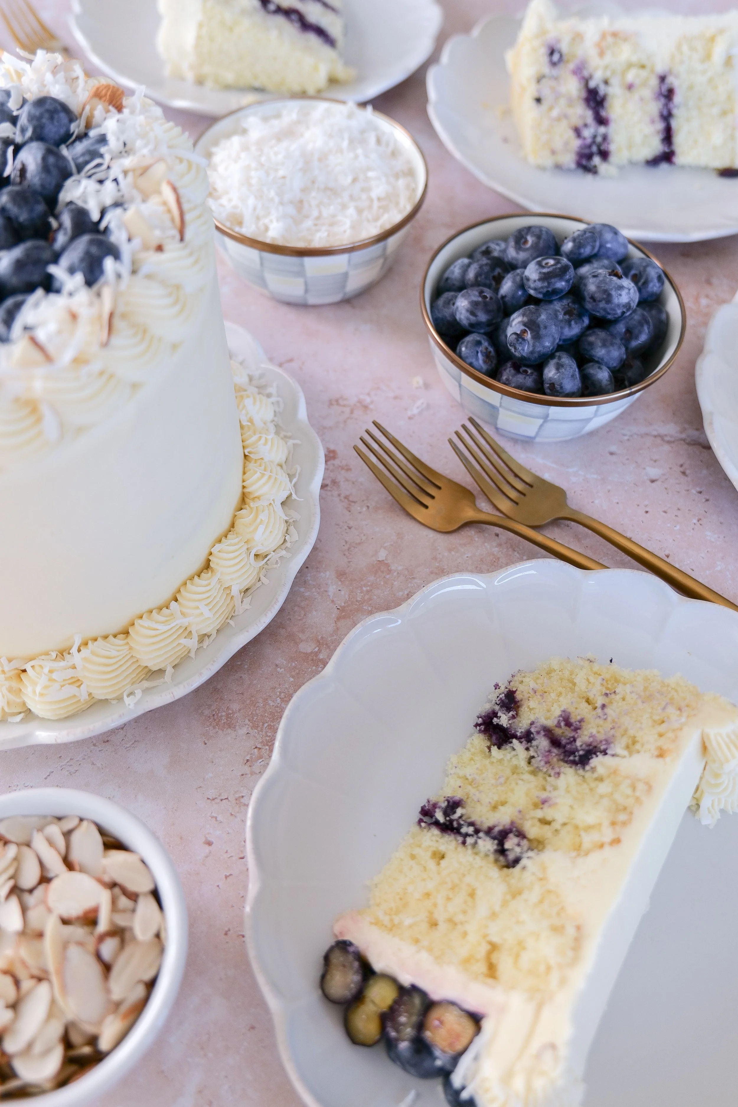 Slice of almond coconut cake showing layers of blueberry curd filling.