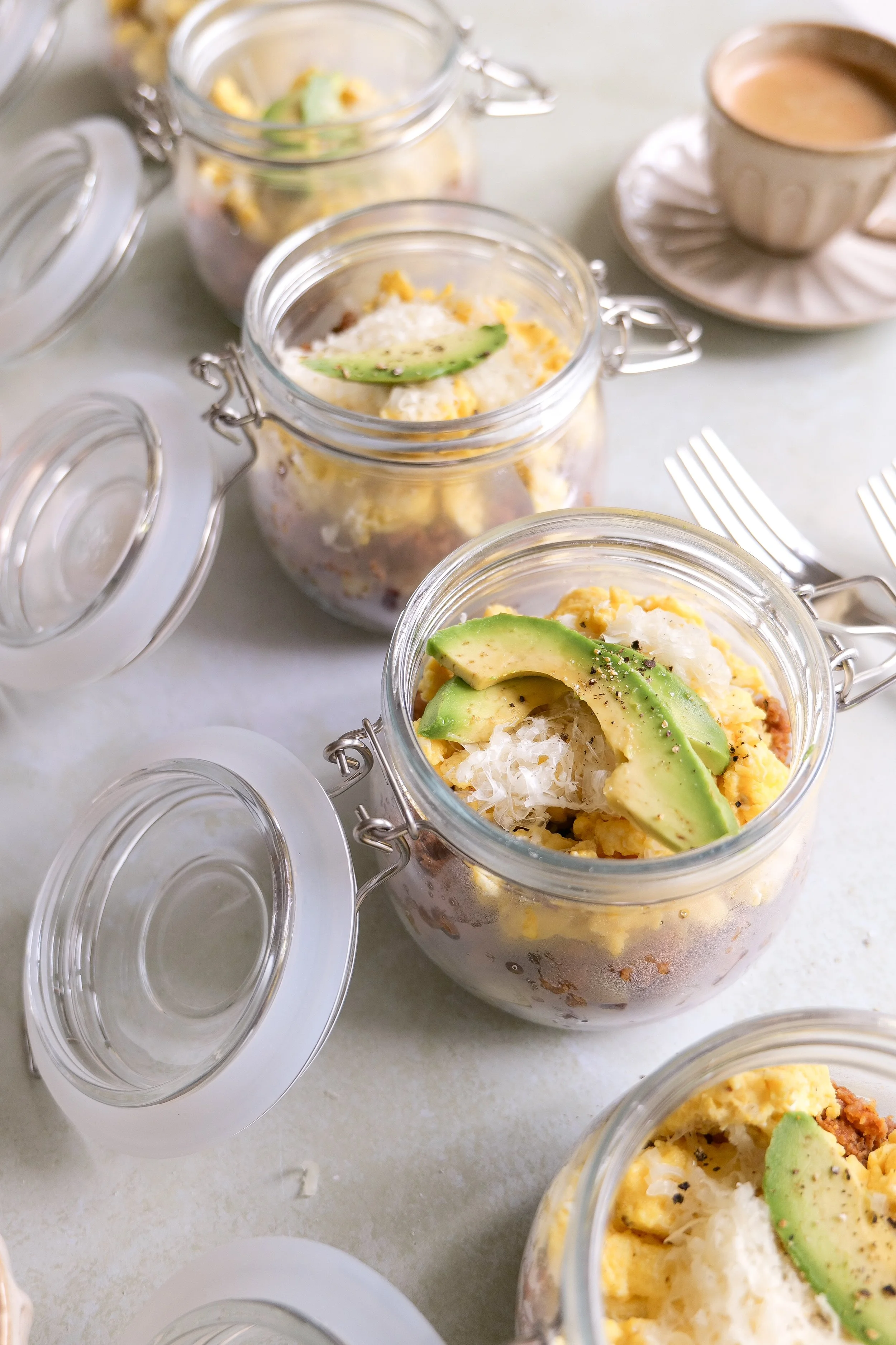 Savory breakfast bowl with chorizo, eggs, crispy potatoes, mozzarella and sliced avocado.