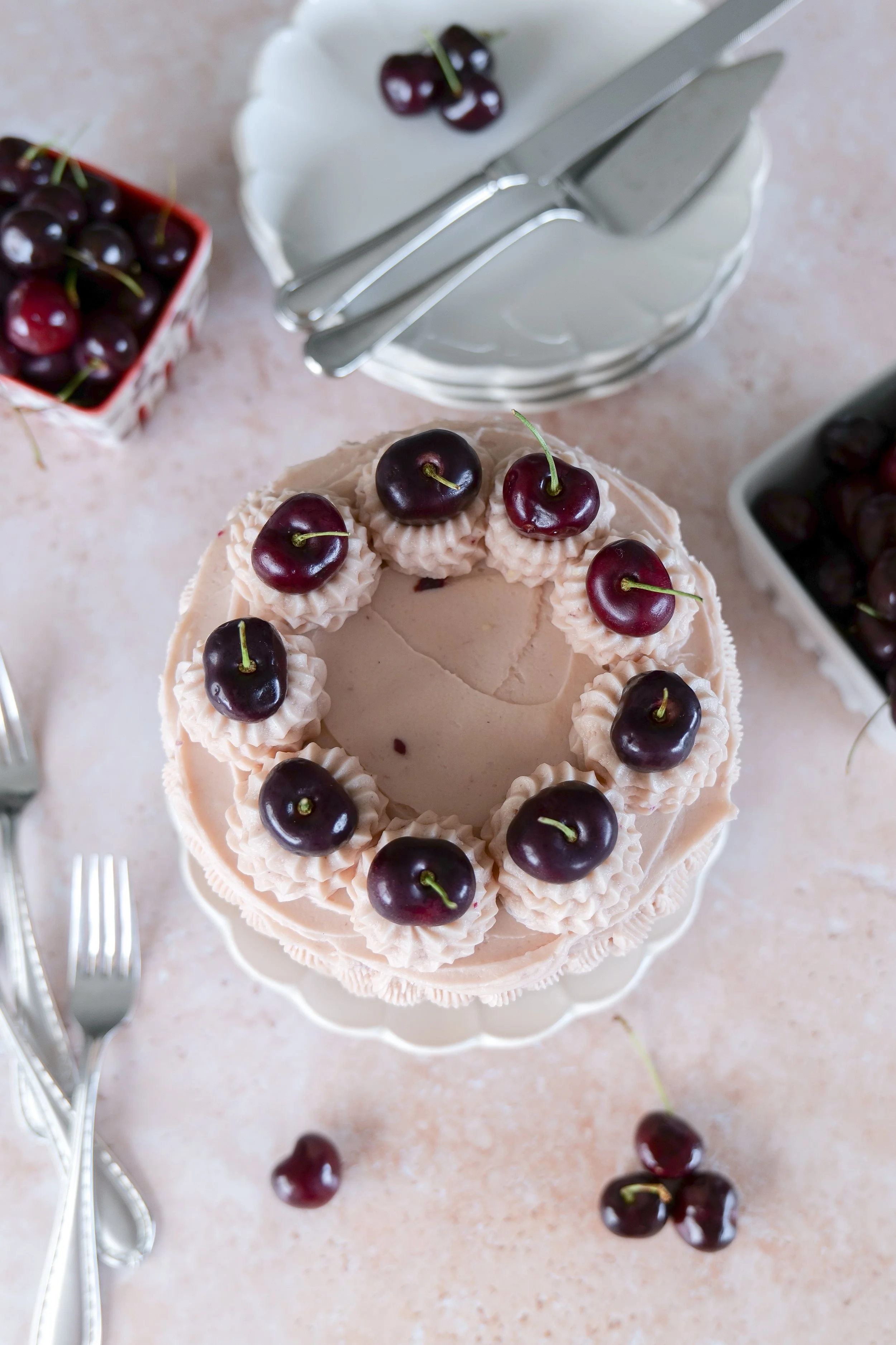 Slice of vanilla bean cherry layer cake showing fluffy vanilla cake layers and fresh cherry filling.