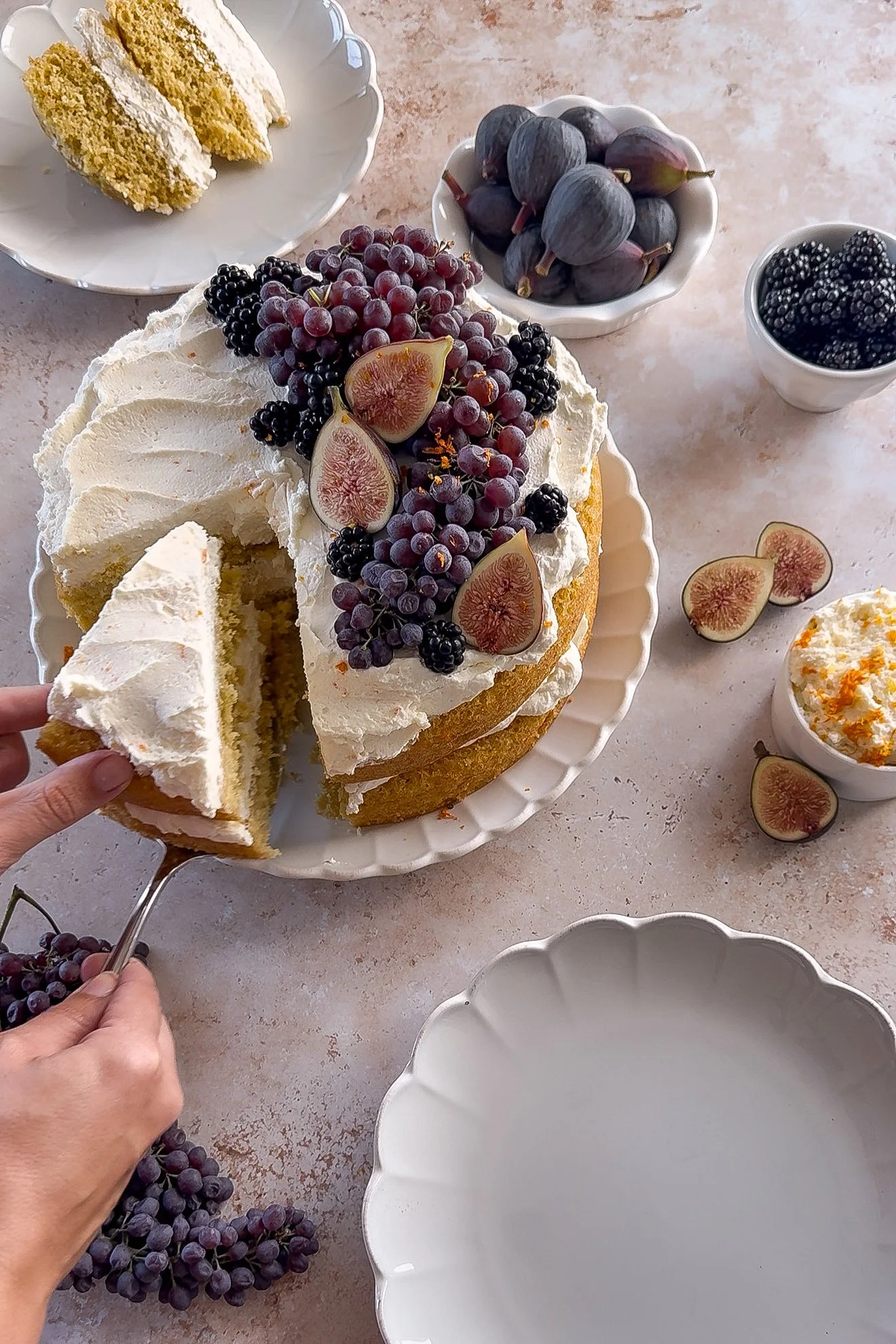 Slice of orange olive oil cake being lifted to show the mascarpone cream between the layers