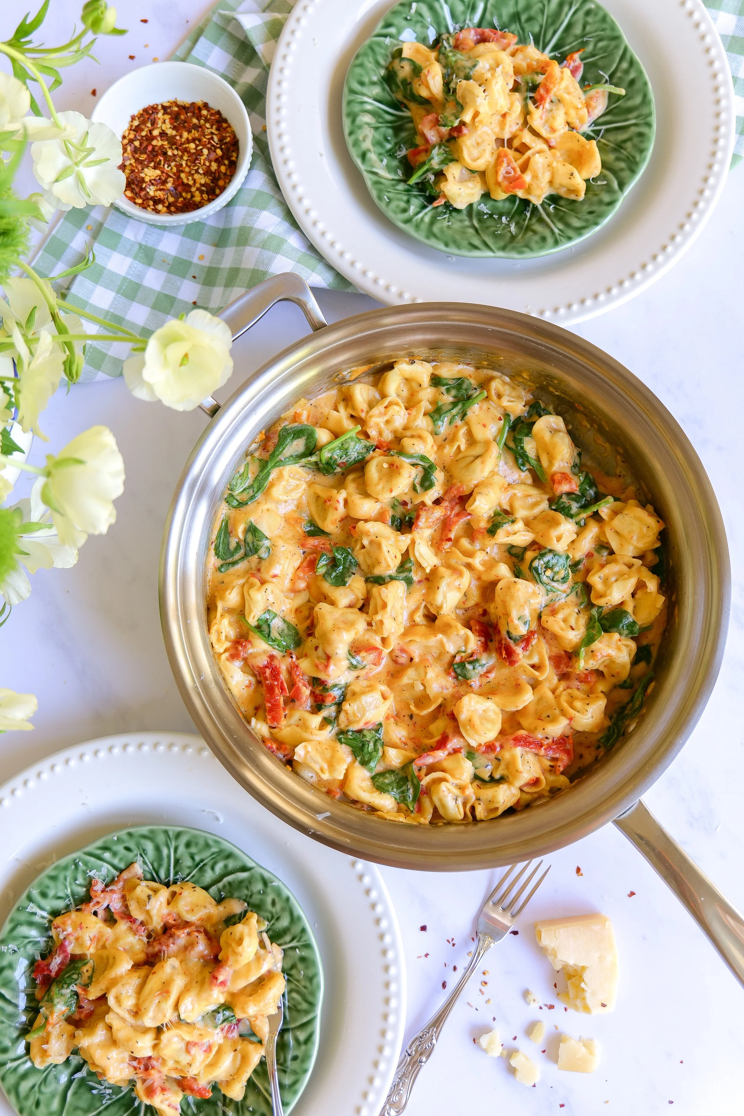 One Pot Marry Me Tortellini served in a pan with plates ready at the table