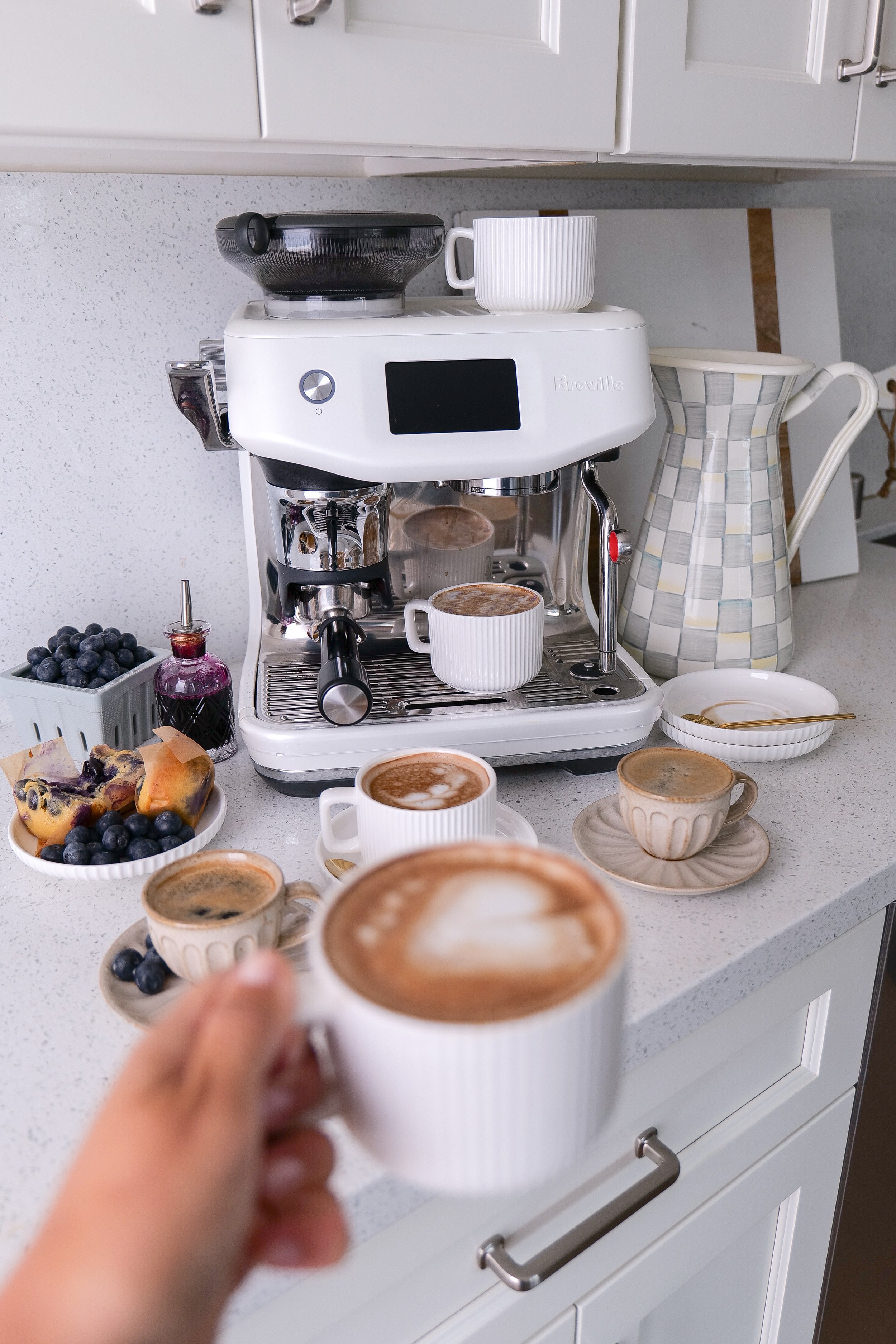 Cozy coffee table styled with Blueberry Muffin Lattes, fresh blueberries, and homemade blueberry syrup.