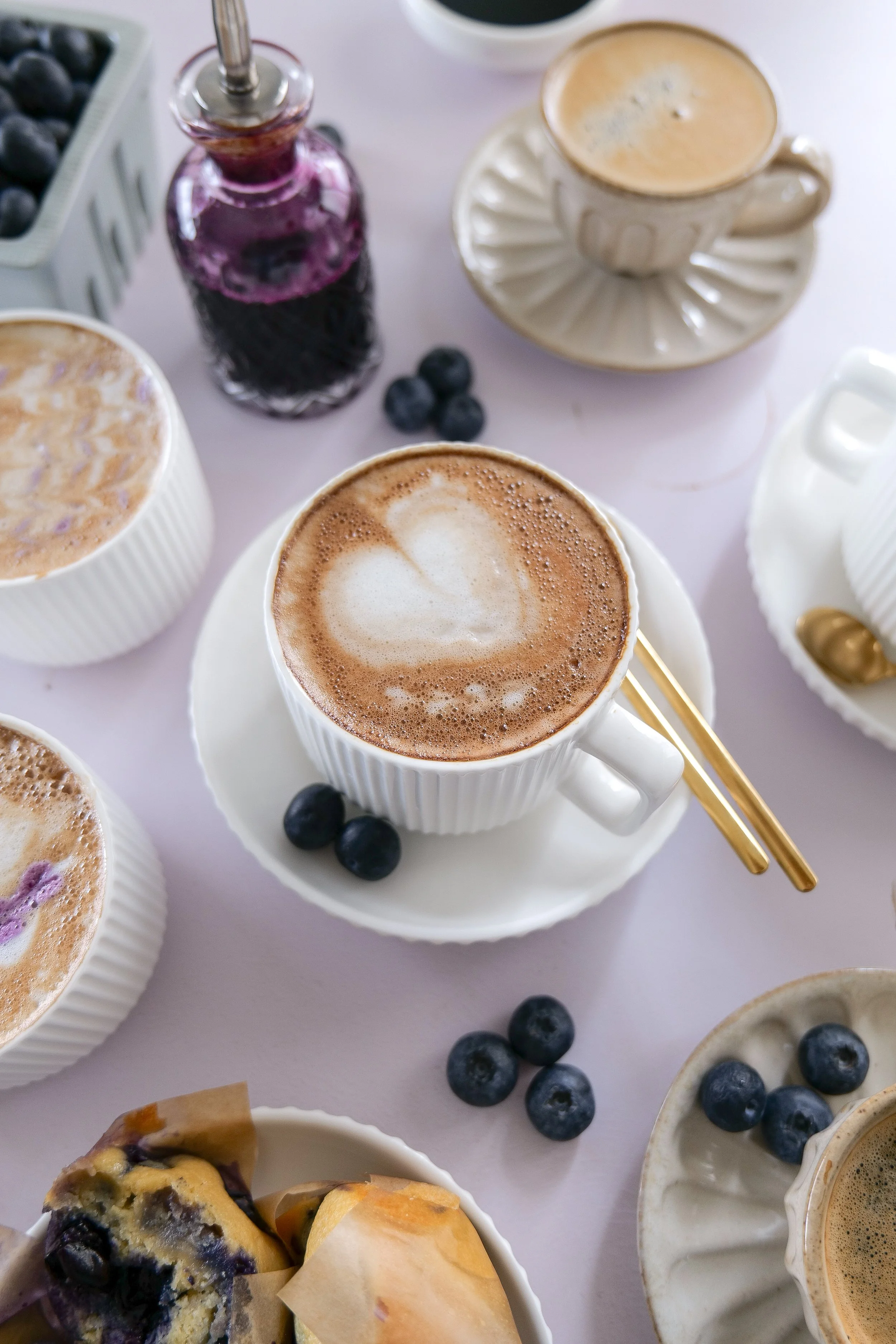 Overhead view of a homemade Blueberry Muffin Latte with espresso, milk, and blueberry syrup.