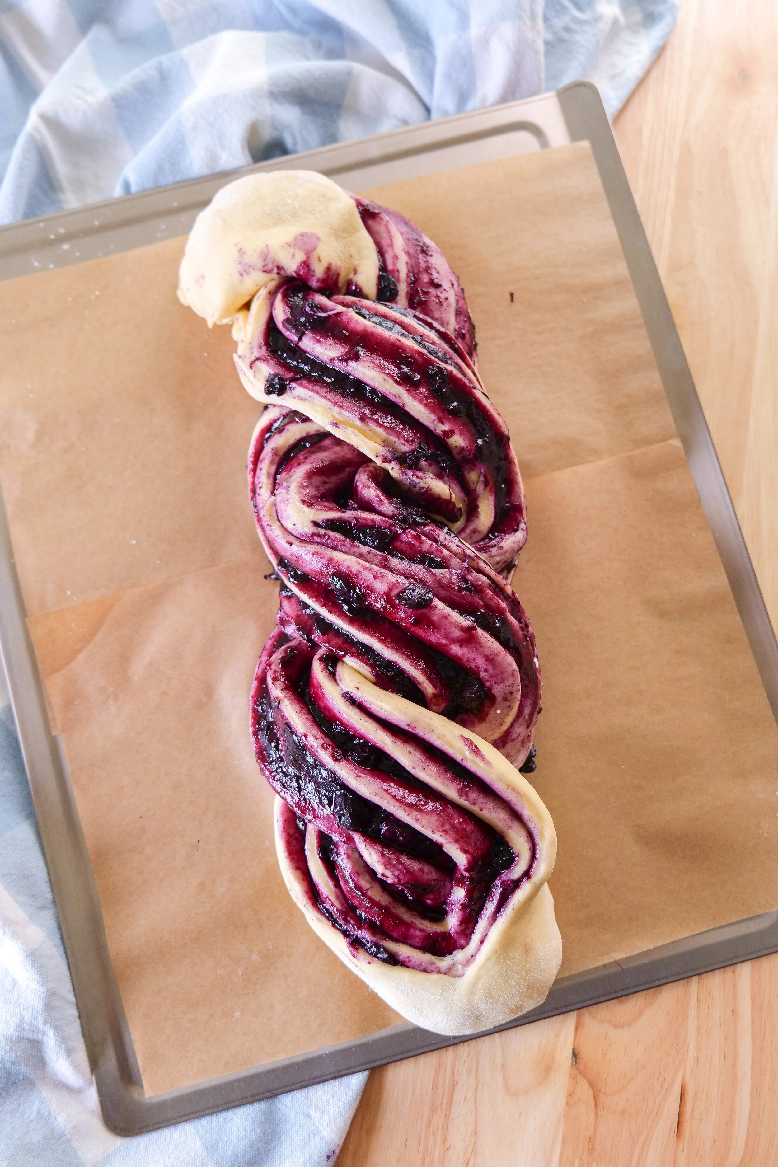 Homemade yeast dough rolled into a rectangle for blueberry cinnamon roll bread.