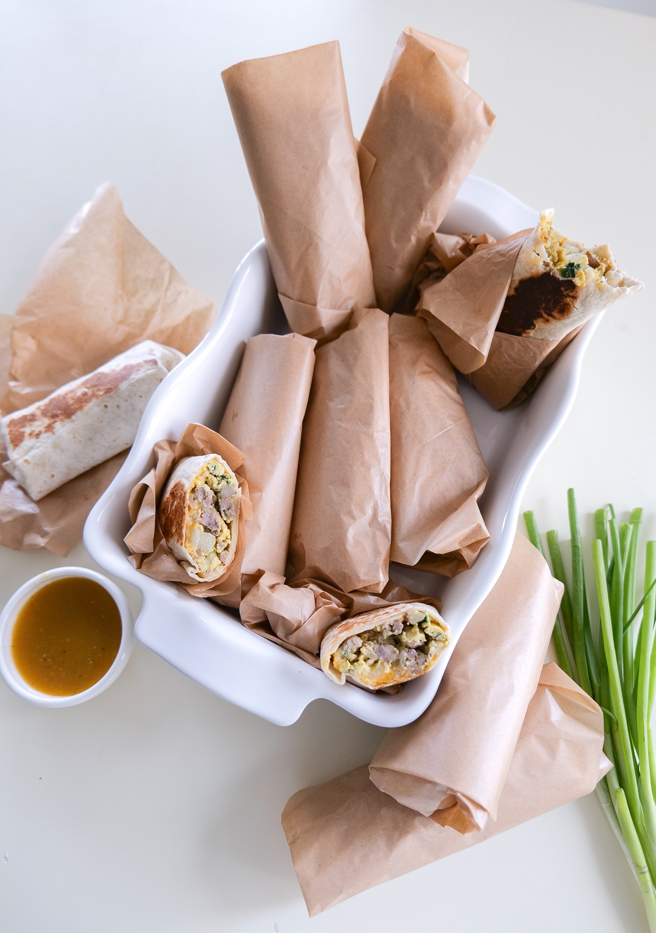 Easy freezer breakfast burritos wrapped in parchment paper and ready to store for quick breakfasts throughout the week.
