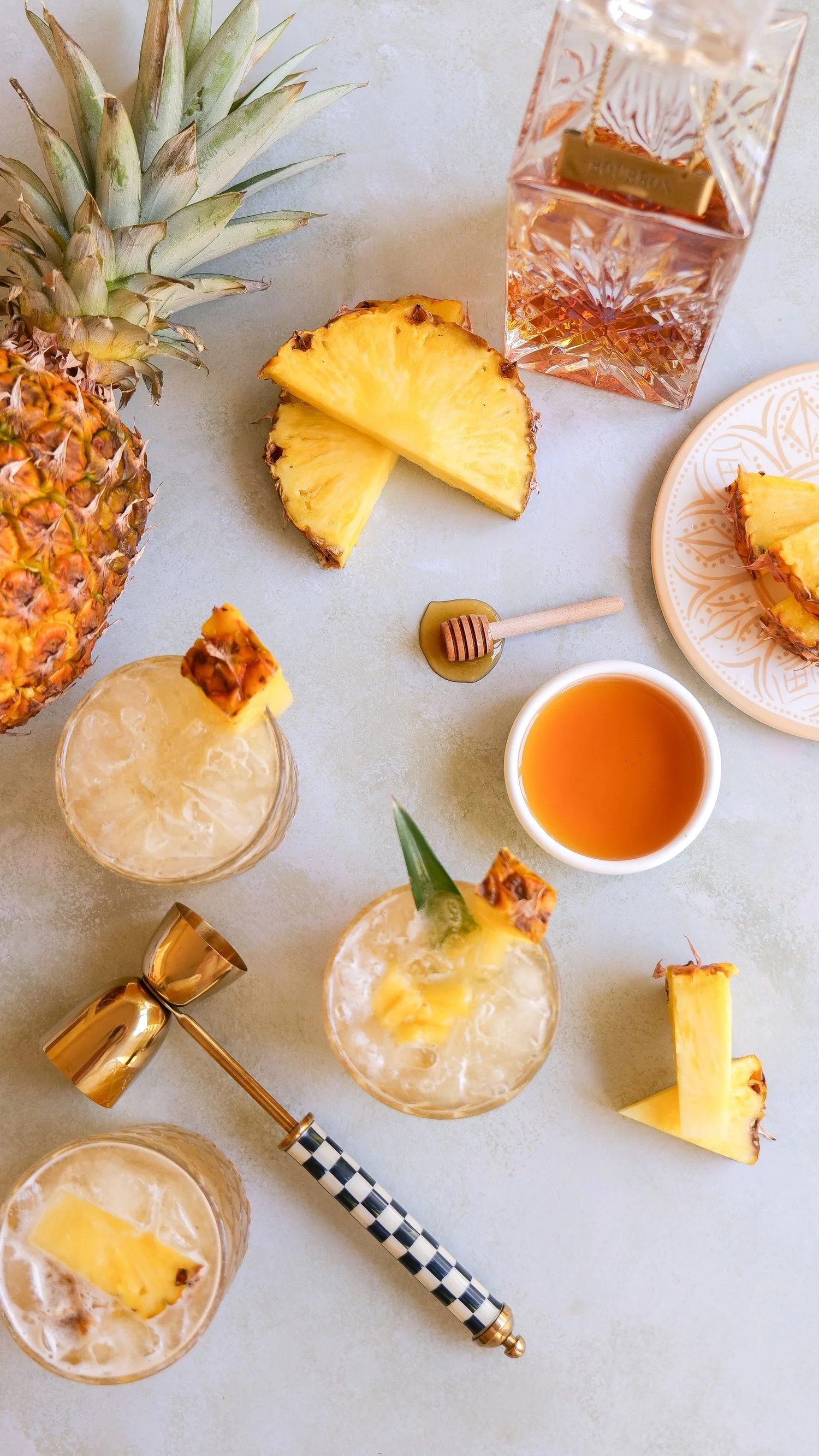 Pineapple bourbon cocktail garnished with fresh pineapple