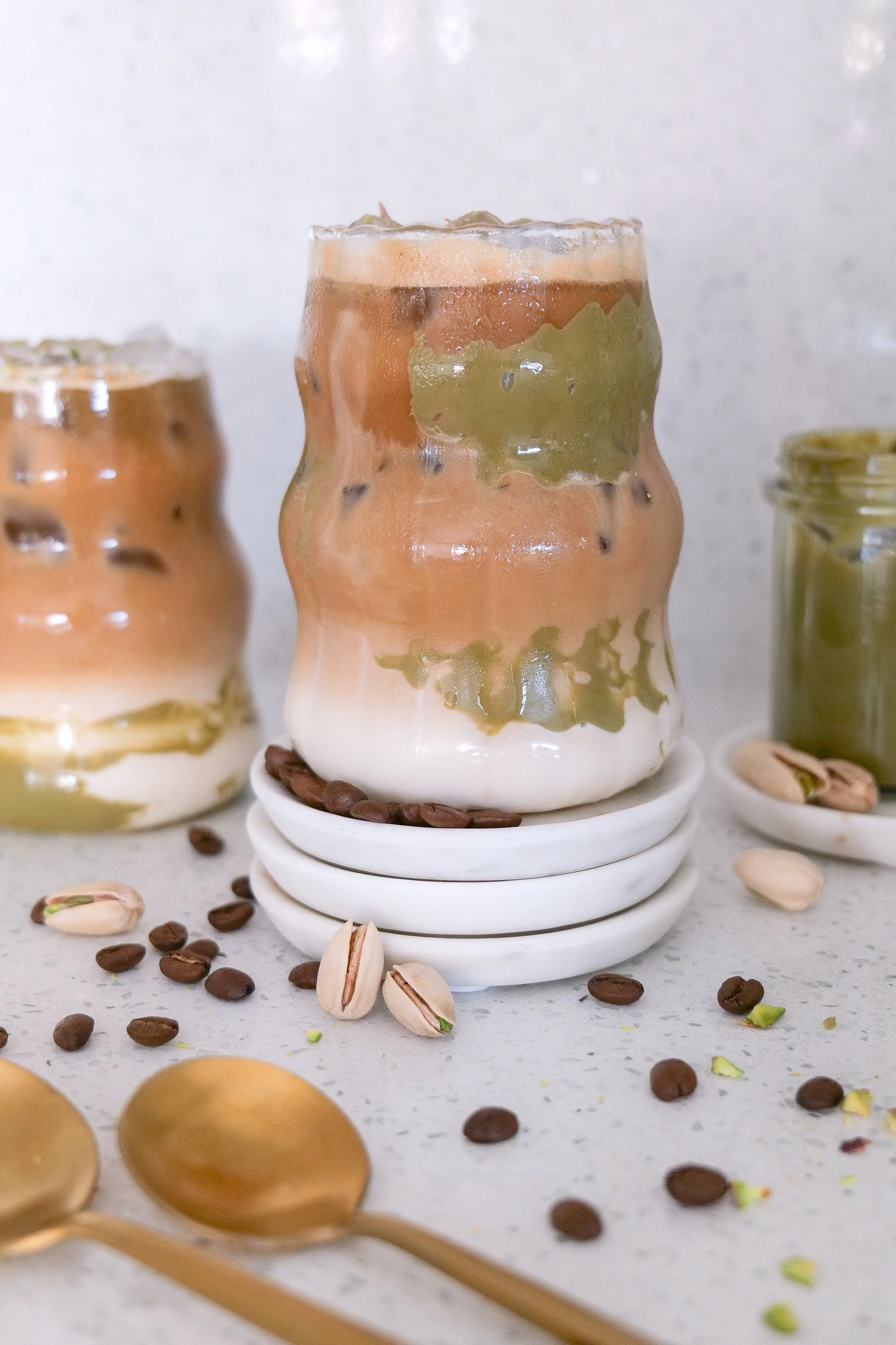 Iced pistachio latte made with espresso, creamy pistachio milk, ice, and pistachio cream.