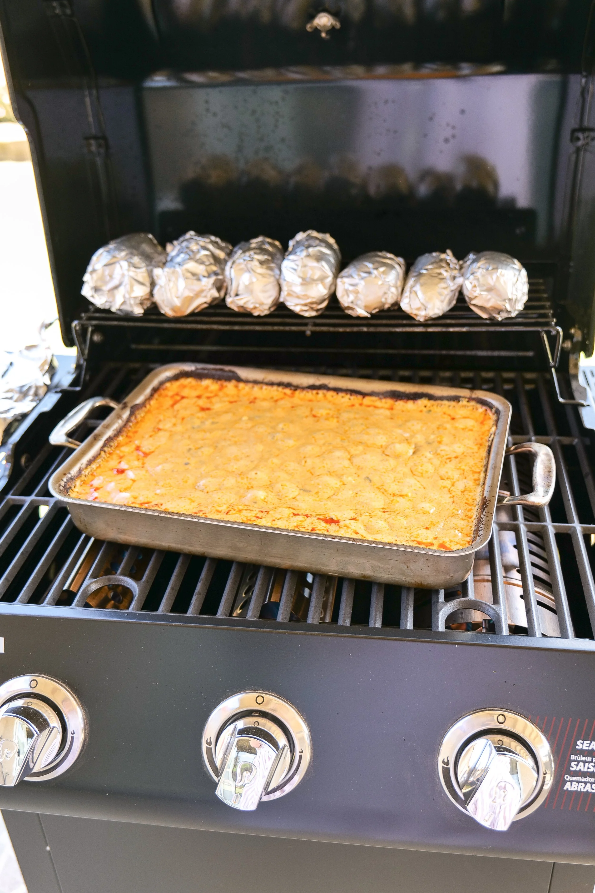 Chorizo queso ingredients combined in a pan while grilling