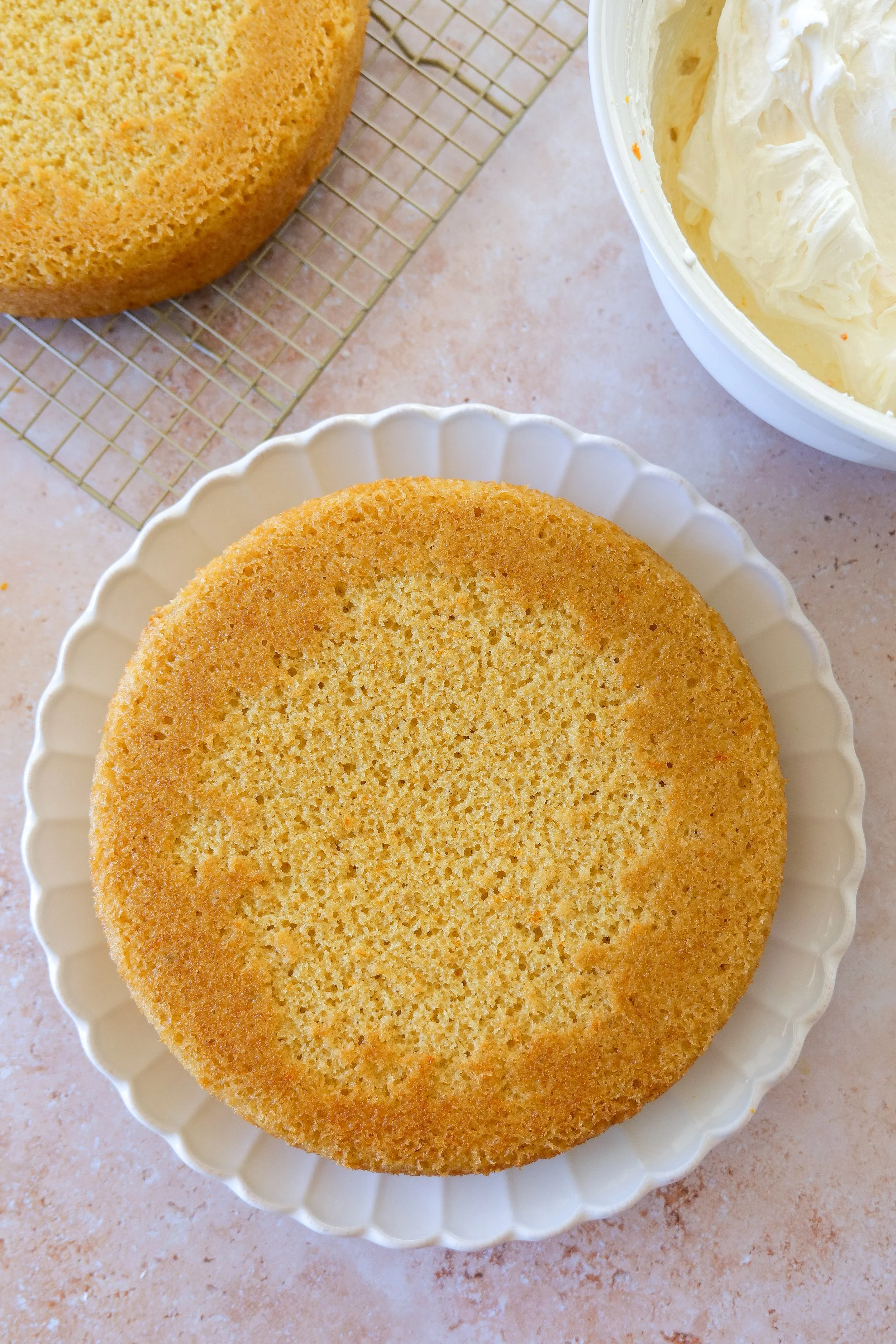 Two baked orange olive oil cake layers cooling before assembling the cake
