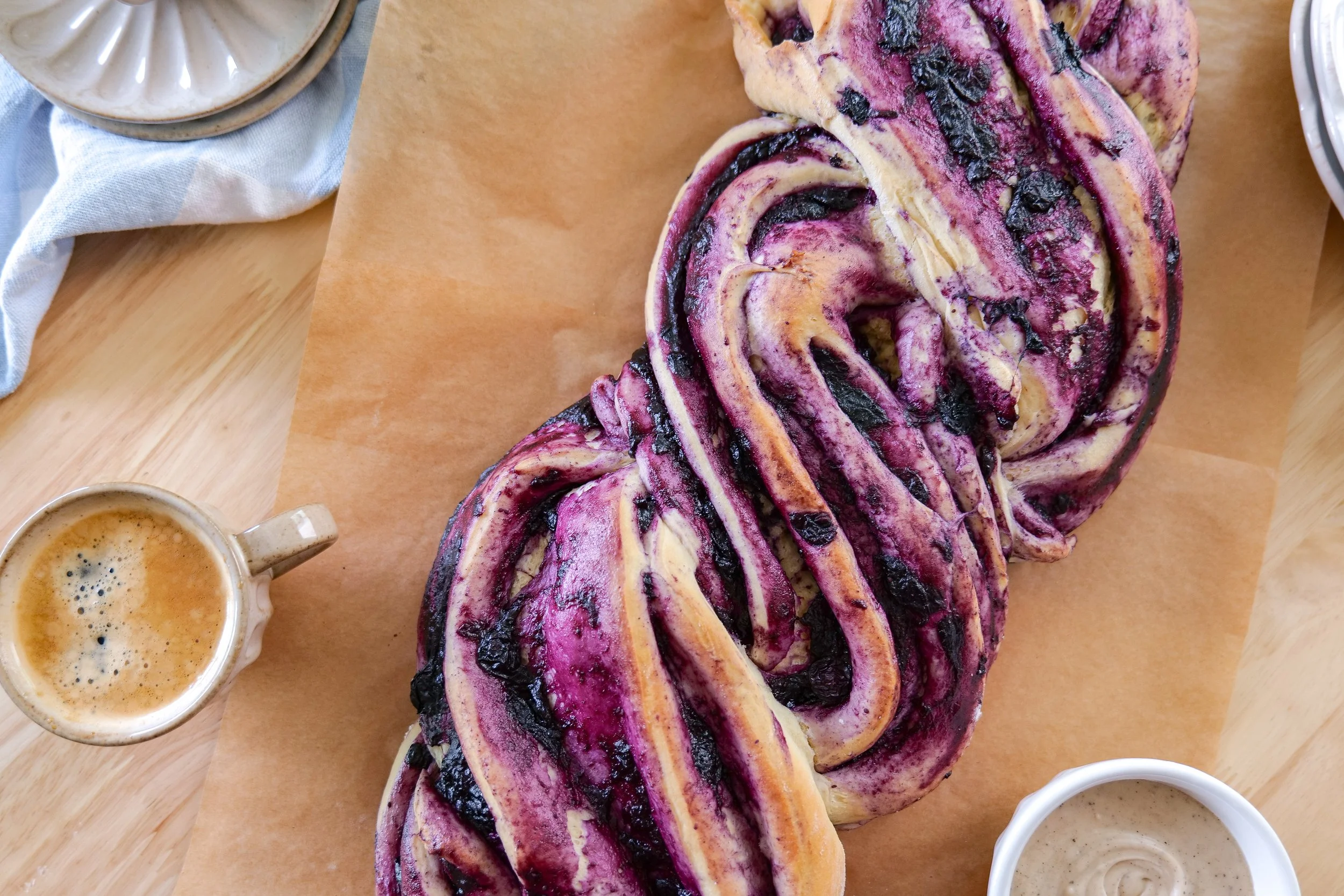 Freshly baked blueberry cinnamon roll loaf with golden brown twisted layers.